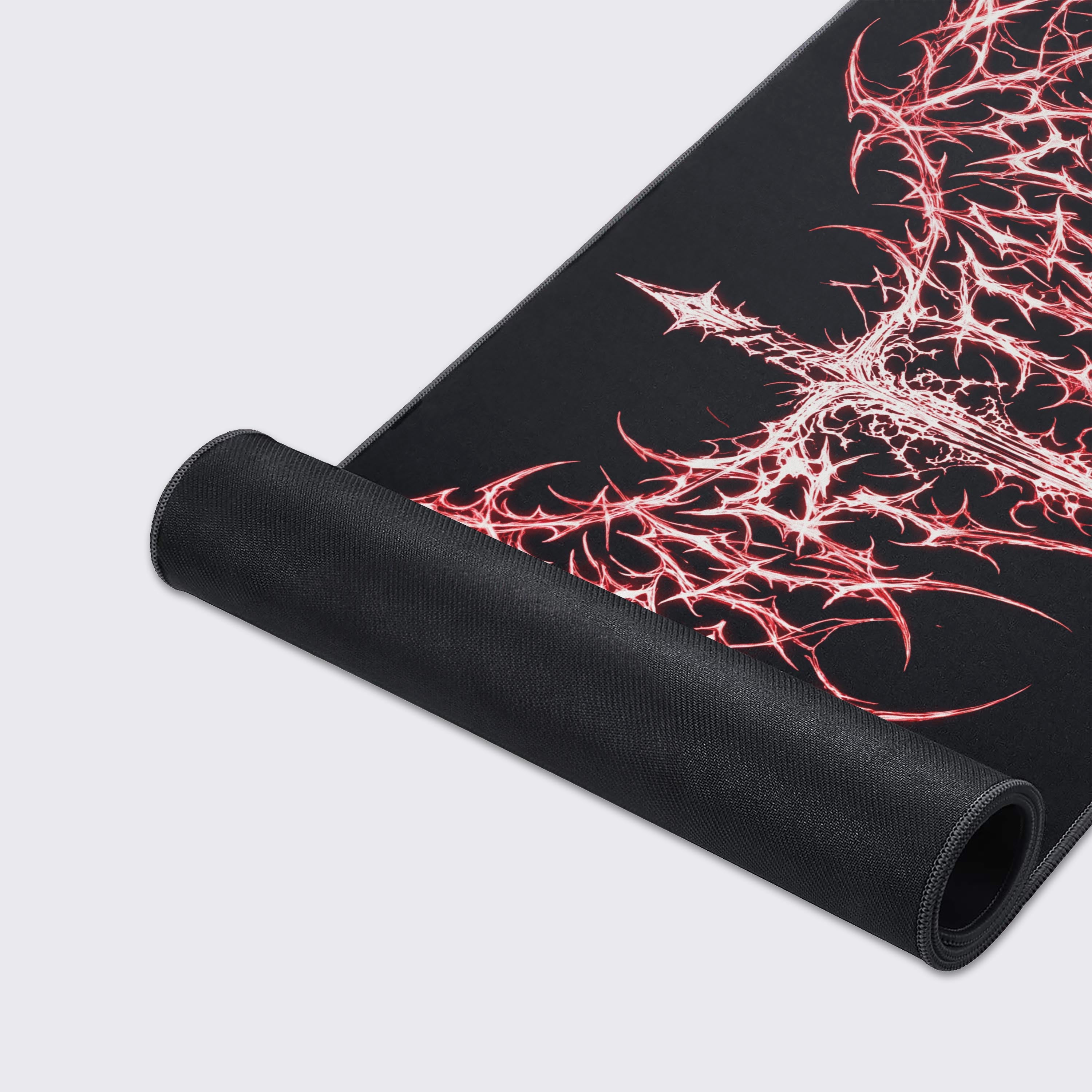 Top-down view of the desk mat highlighting the striking contrast between the glowing red art and deep black void
