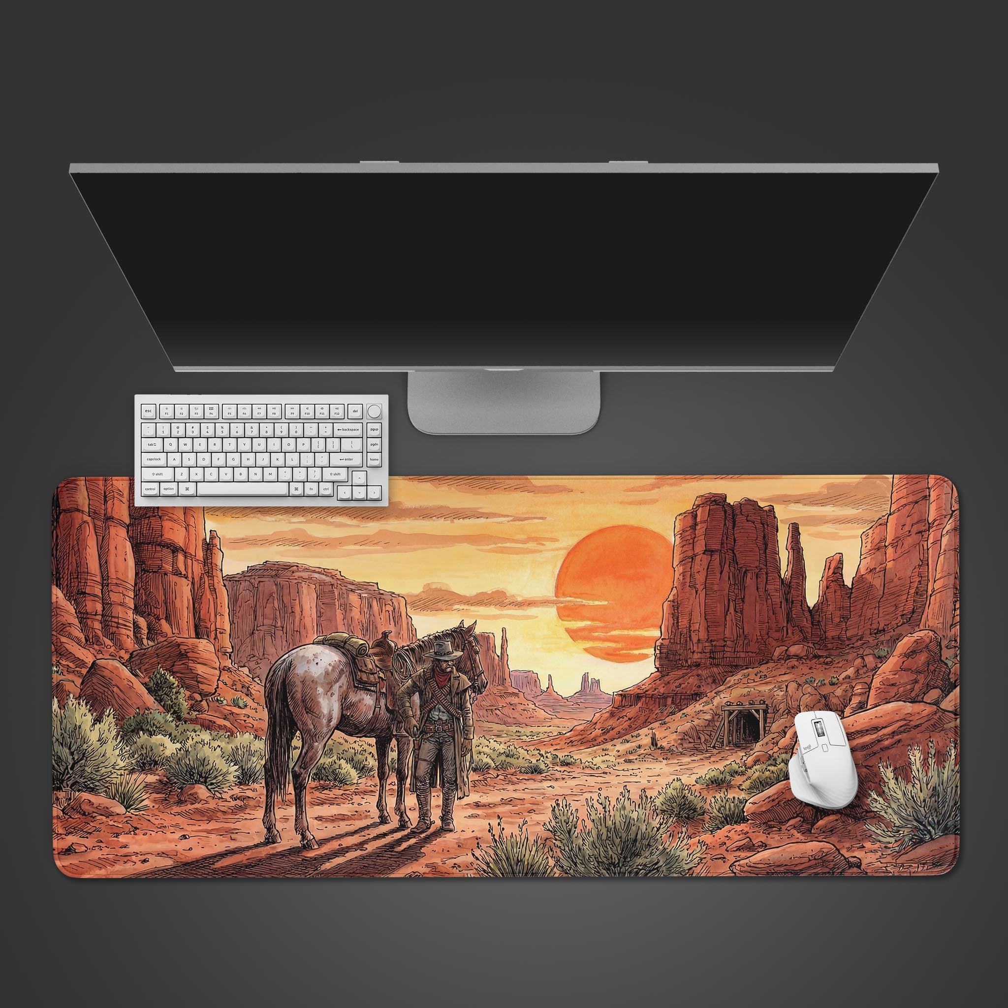 Top-down view of the Desert Wanderer gaming desk mat featuring a western canyon scene, positioned on a desk with a white keyboard and mouse. - Epic Design Pads & Mousepads
