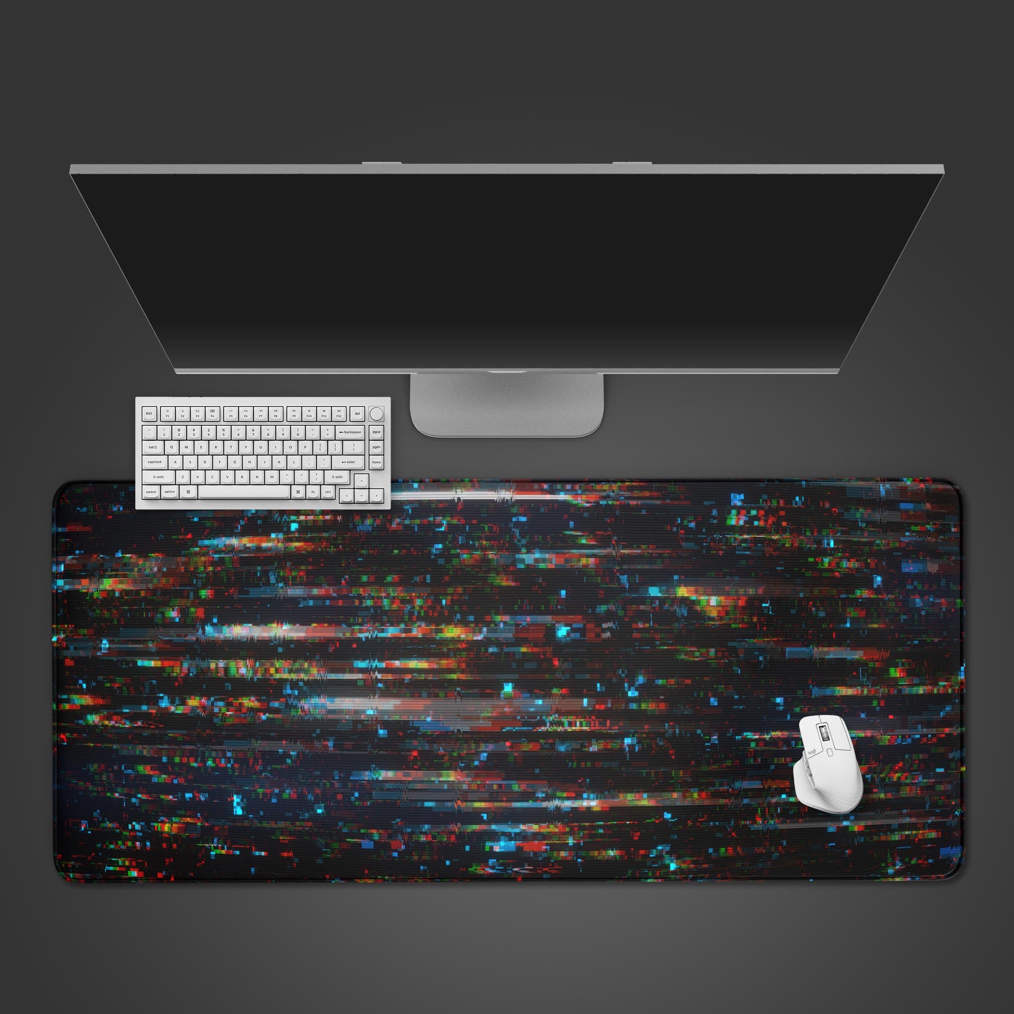 Digital Glitch desk mat with abstract red, cyan, and blue streaks, shown in a desktop view with a black keyboard and mouse. - Epic Design Pads