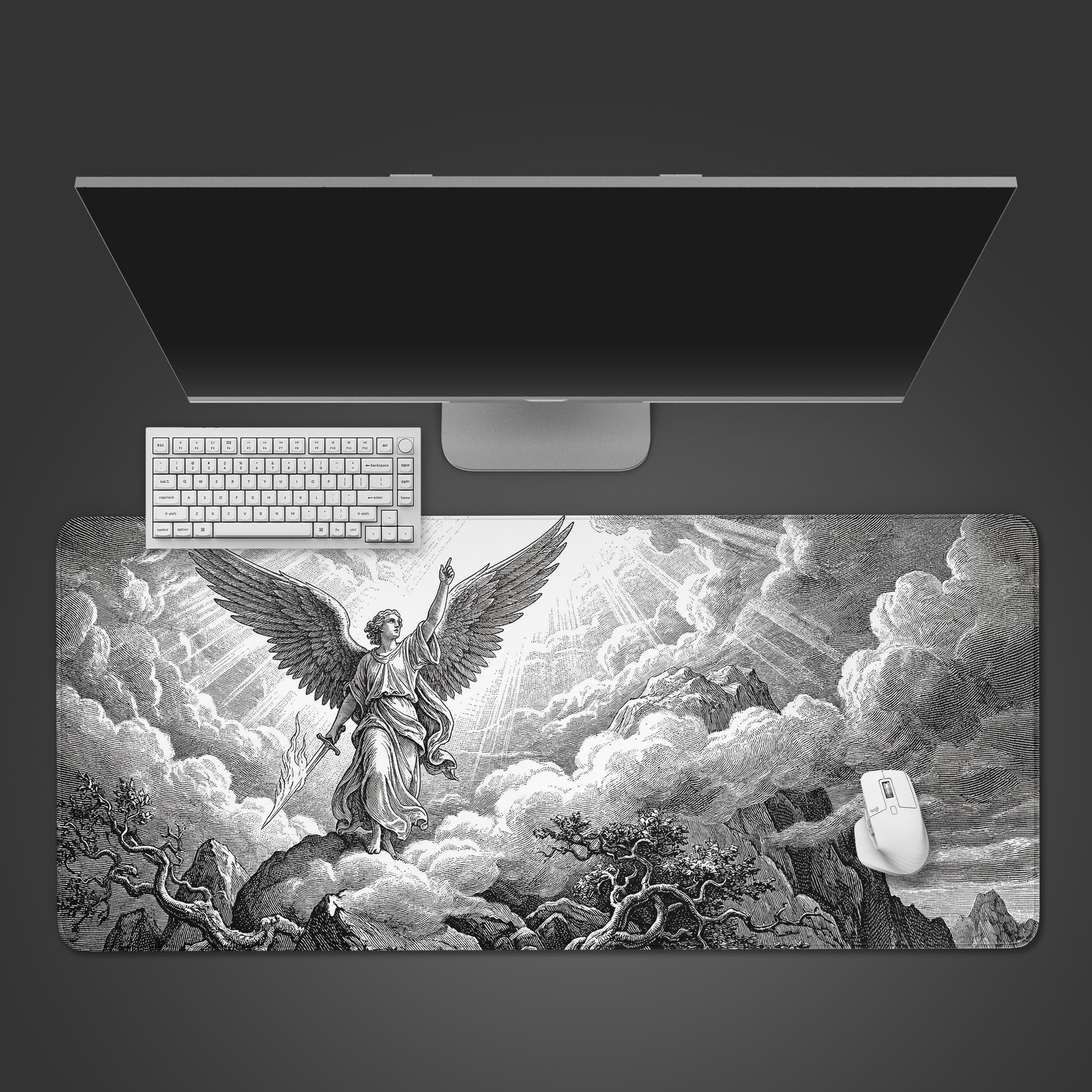 A top-down view of the Divine Ascent Gaming Desk Mat, featuring a black and white angel design. A white keyboard and mouse are placed on the mat below a sleek monitor. - Epic Design Pads & Mousepads
