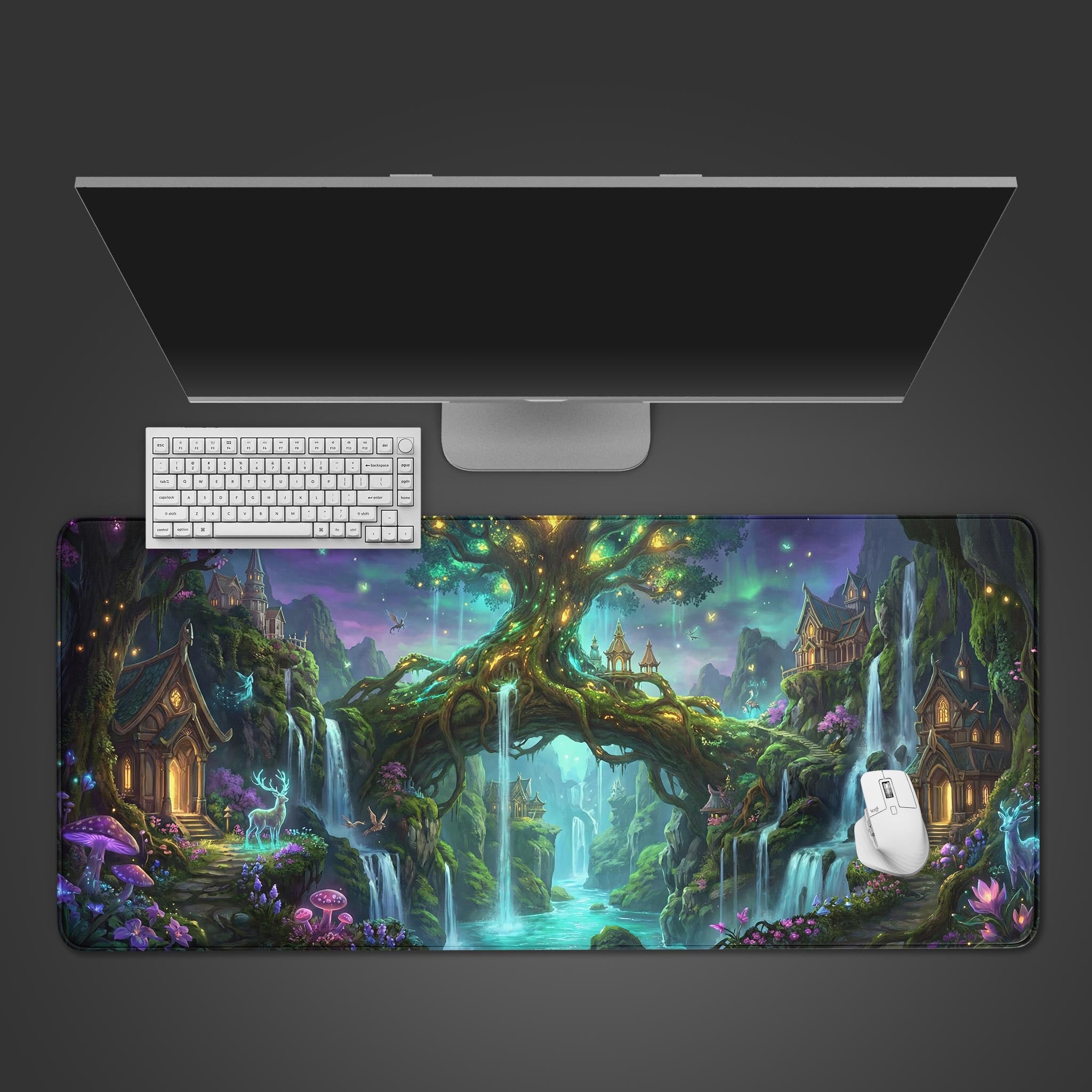 Top-down view of the Enchanted Sanctuary gaming desk mat, showcasing the magical tree design beneath a white keyboard, mouse, and monitor. - Epic Design Pads & Mousepads
