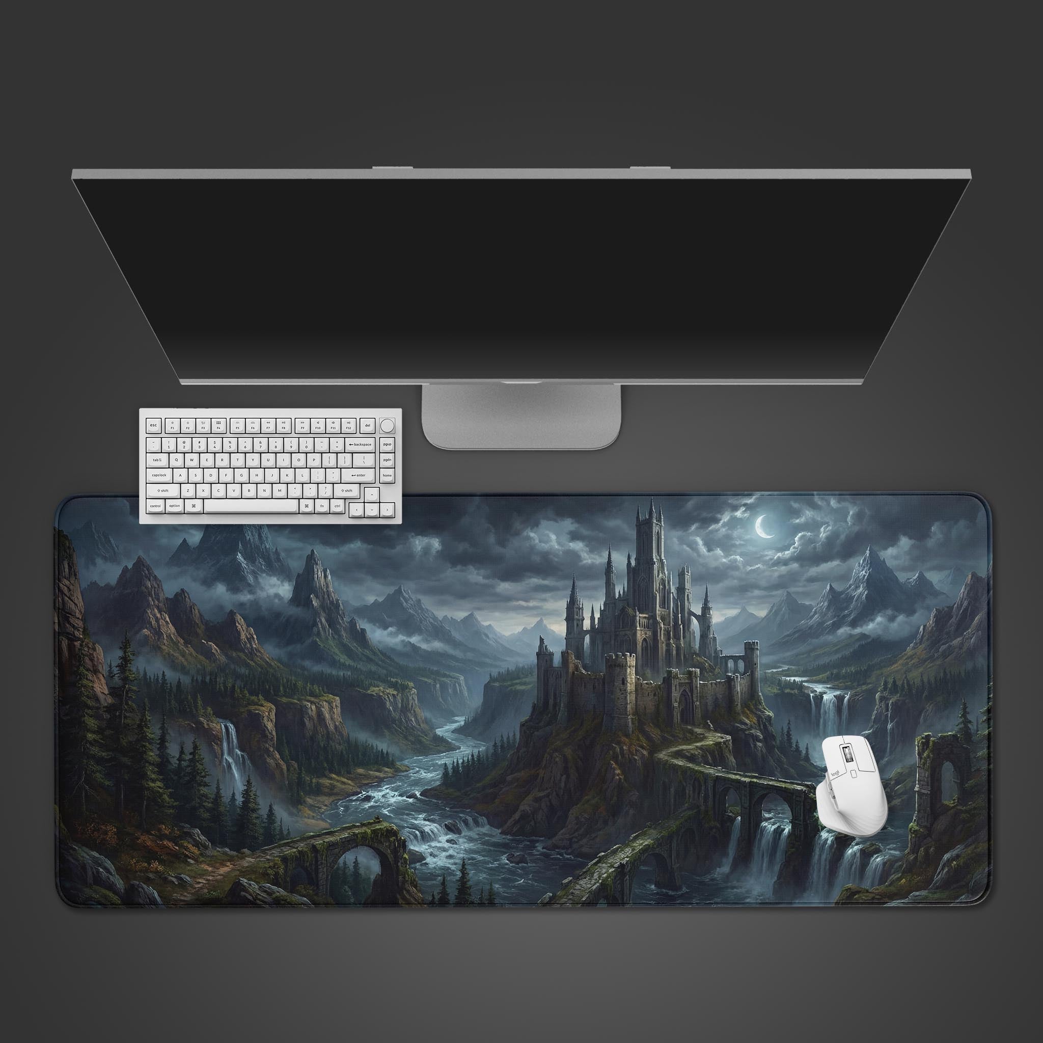 Top-down view of the Forgotten Citadel gaming desk mat, showing the epic fantasy castle design alongside a white keyboard, mouse, and a sleek monitor on a dark background. - Epic Design Pads & Mousepads