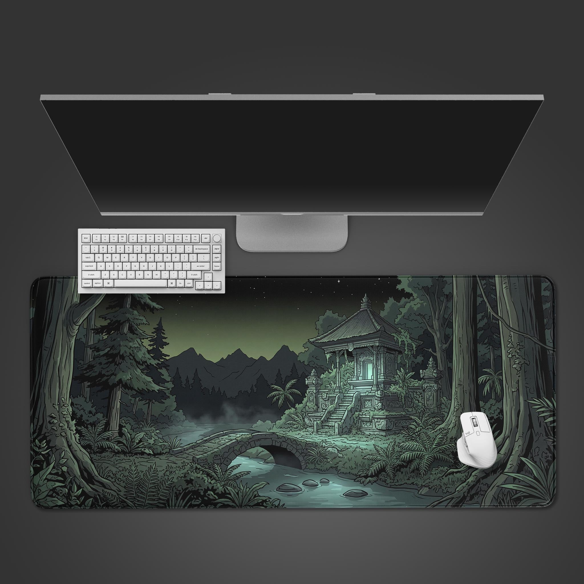 Top-down view of the Forgotten Temple Gaming Desk Mat, showing the dark jungle shrine design beneath a sleek monitor, white keyboard, and mouse. - Epic Design Pads & Mousepads