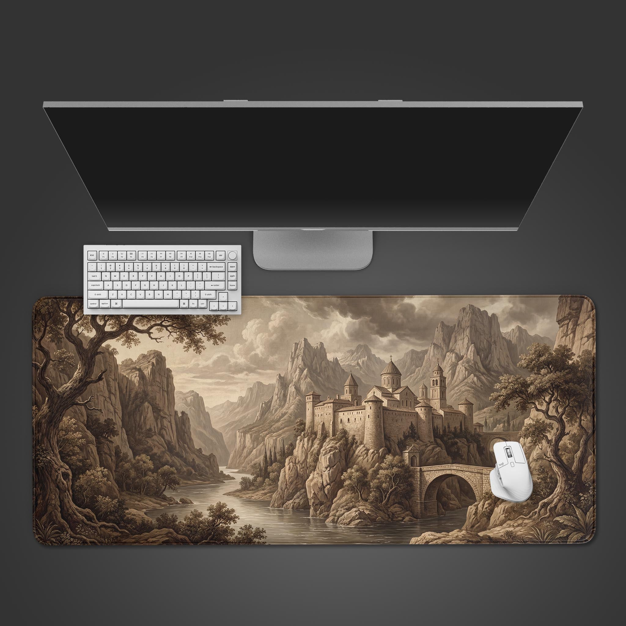 A top-down view of the 'Fortress of Solitude' gaming desk mat, featuring a vintage castle design, alongside a white keyboard and mouse on a dark surface. - Epic Design Pads & Mousepads