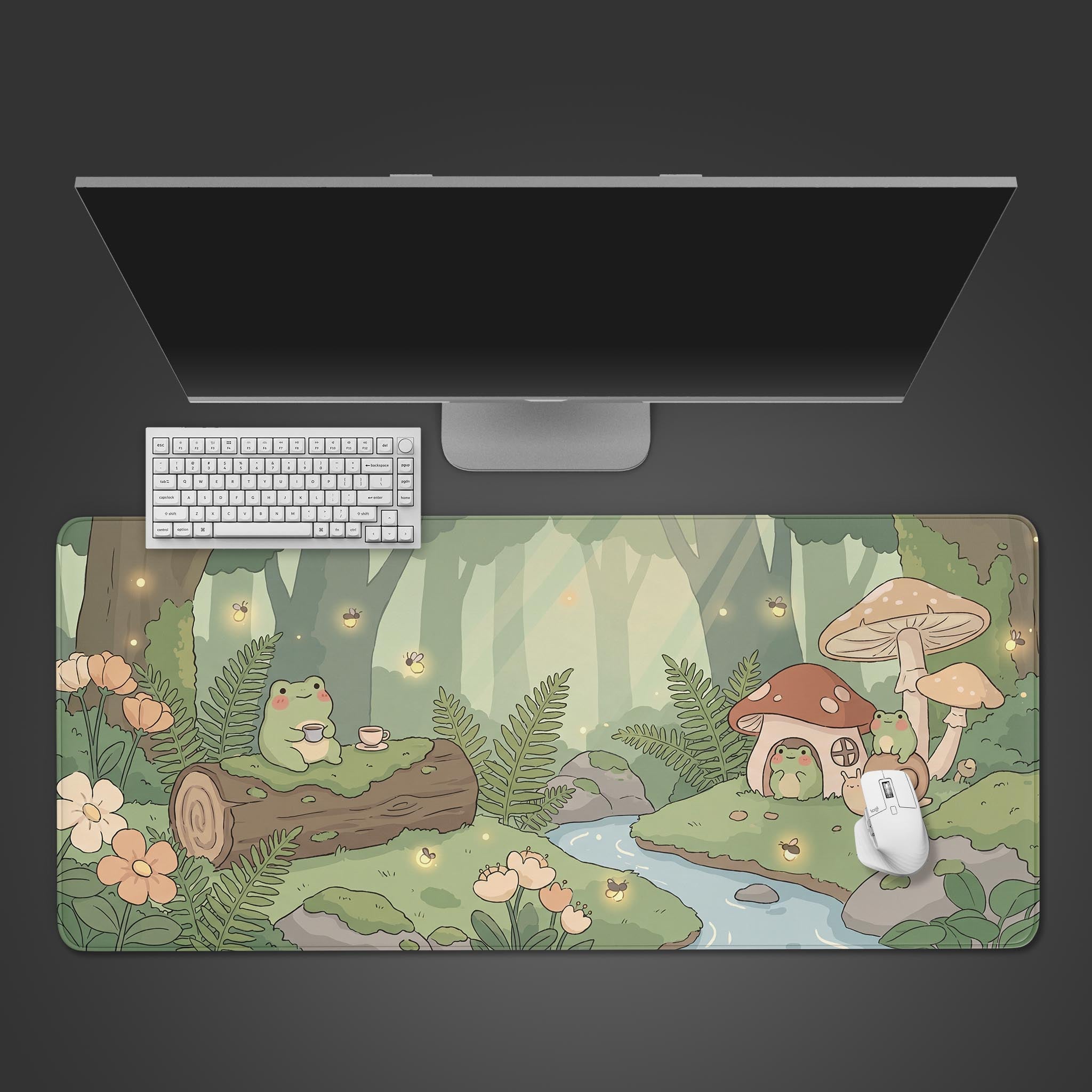 Cute pastel green desk mat featuring a cottagecore illustration of frogs drinking tea in a forest.
