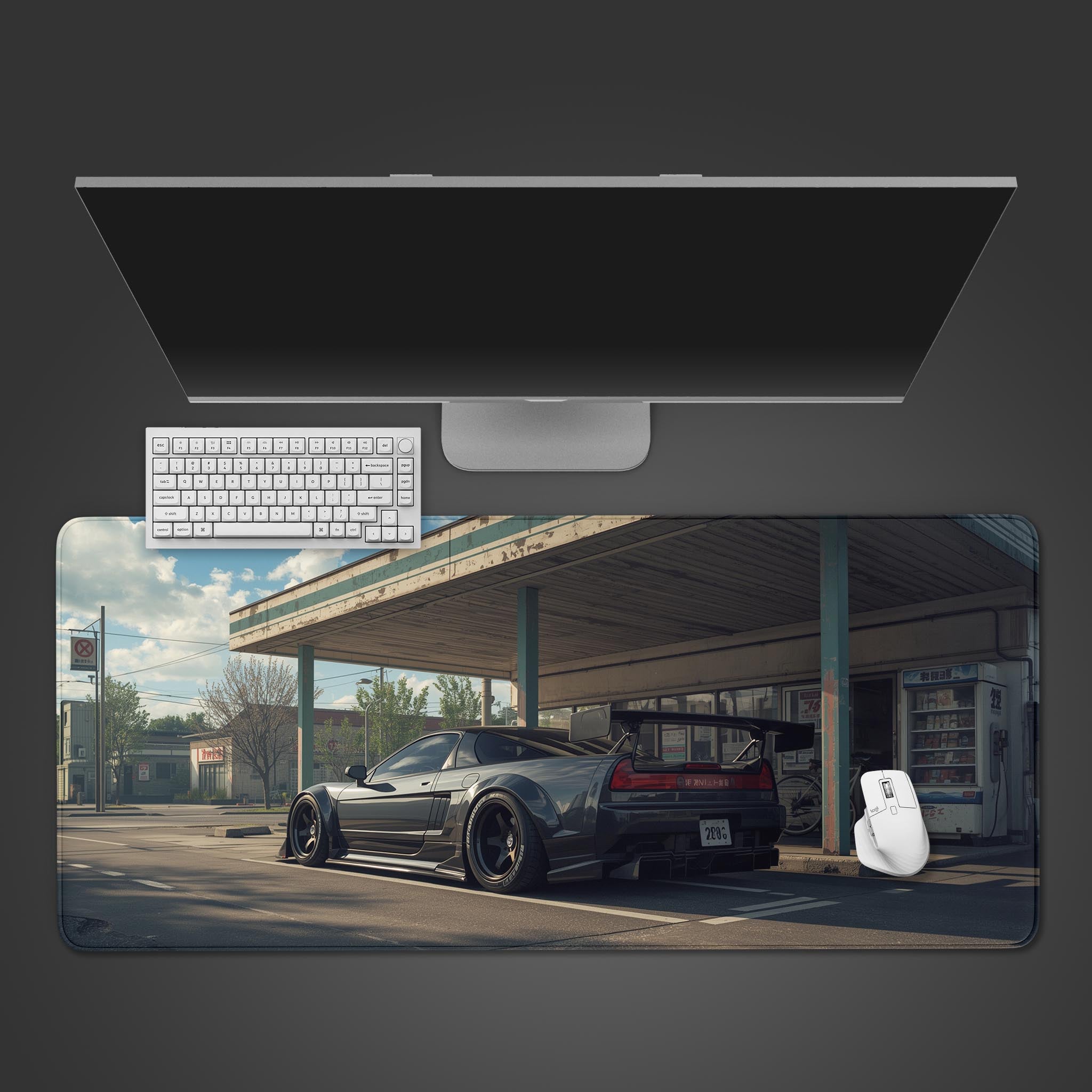 Automotive desk mat featuring black Honda NSX with Japanese gas station design – desktop view with keyboard. - Epic Design Pads