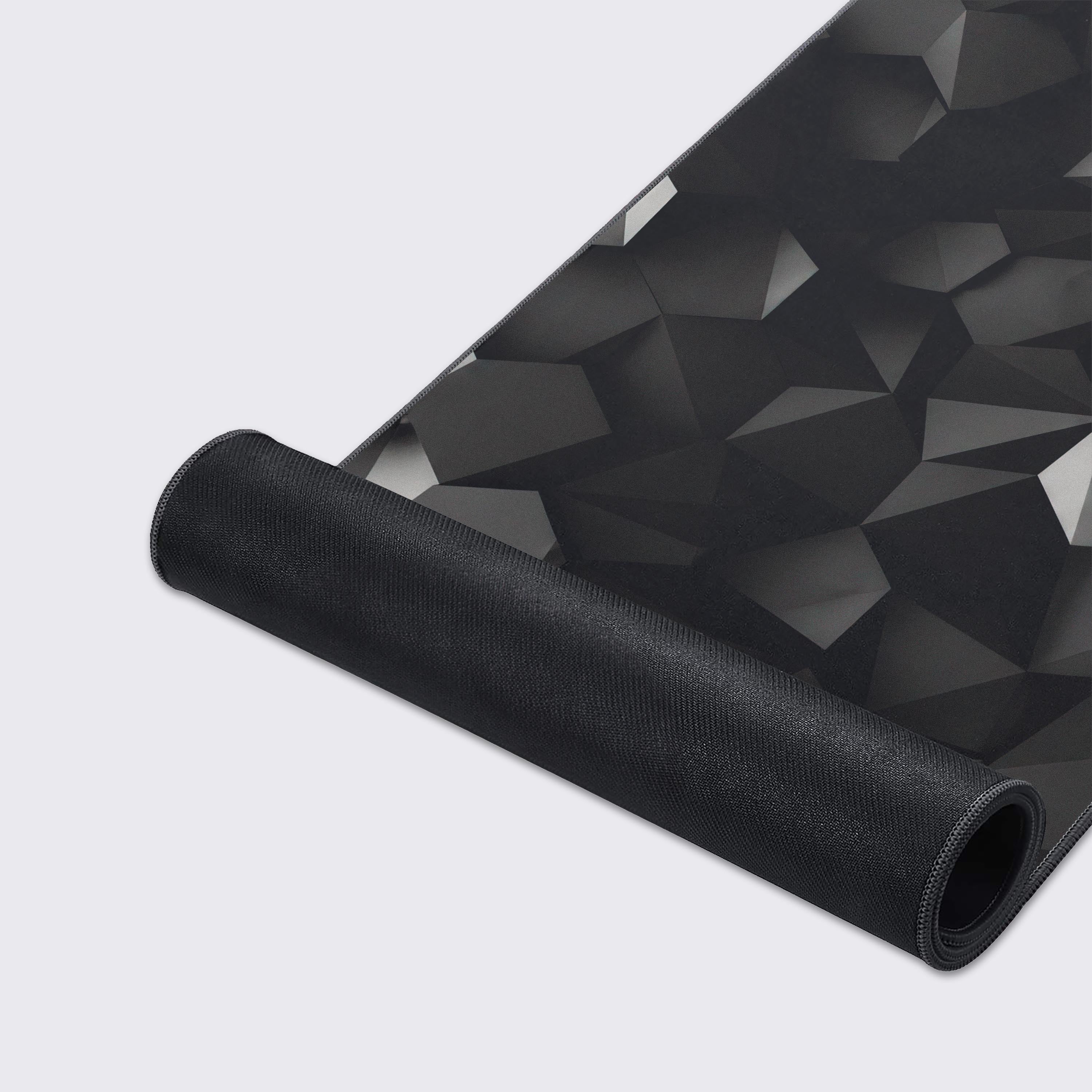 The black geometric desk mat showing off its water-proof and easy-to-clean surface features.
