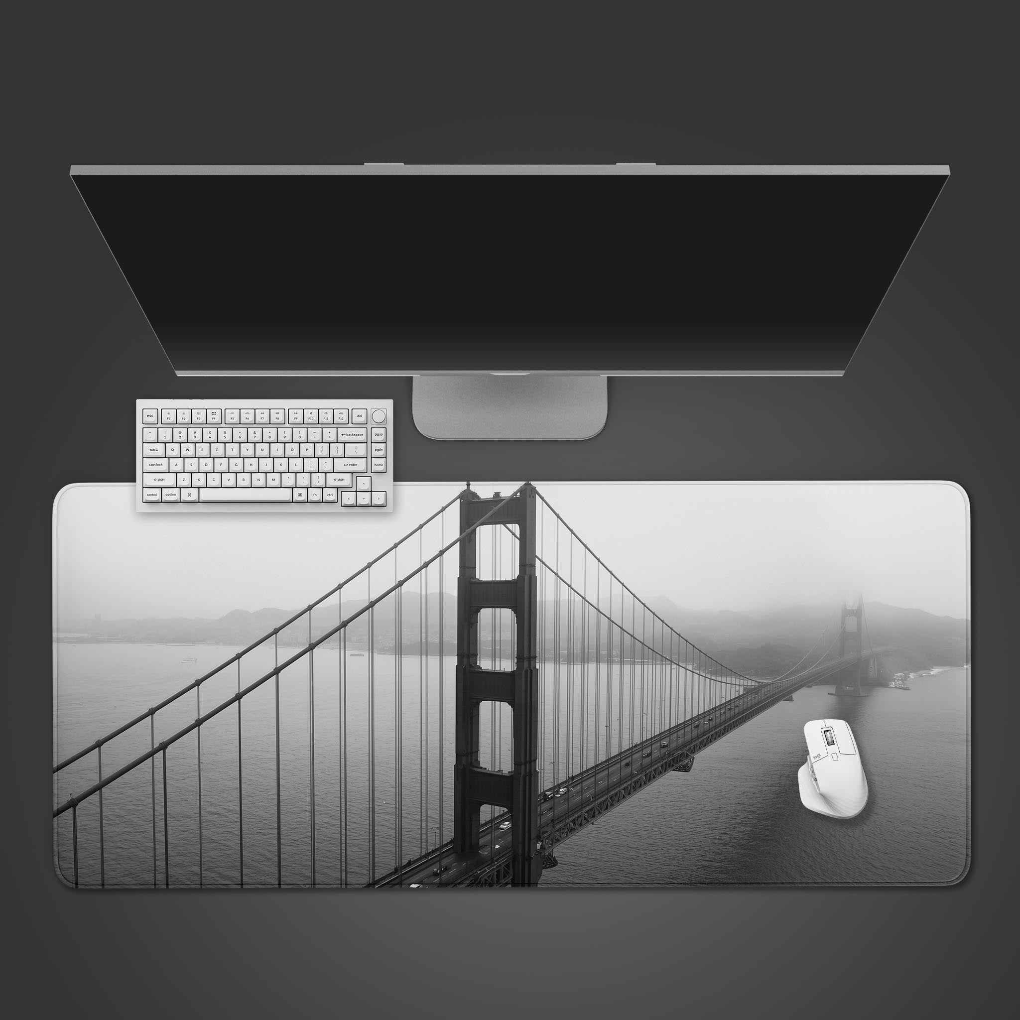 Golden Gate Bridge desk mat in black and white, shown from a top-down view with a sleek black keyboard and wireless mouse. - Epic Design Pads