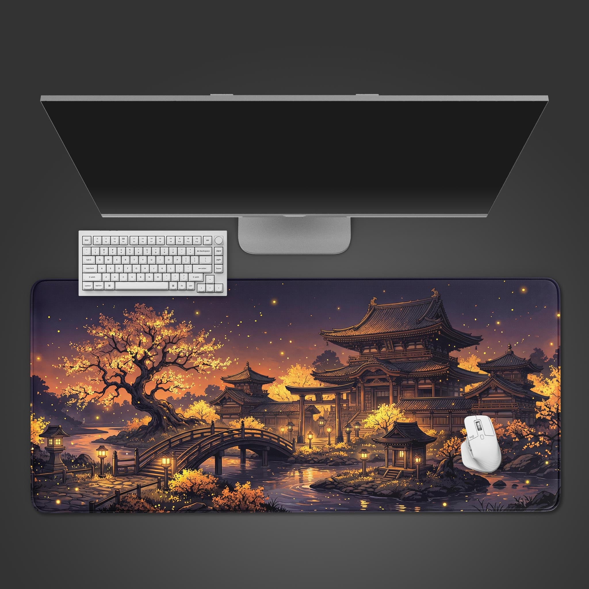 Top-down view of the Golden Pagoda gaming desk mat, featuring a Japanese temple at twilight. A white keyboard and mouse are positioned on the mat below a sleek monitor. - Epic Design Pads & Mousepads