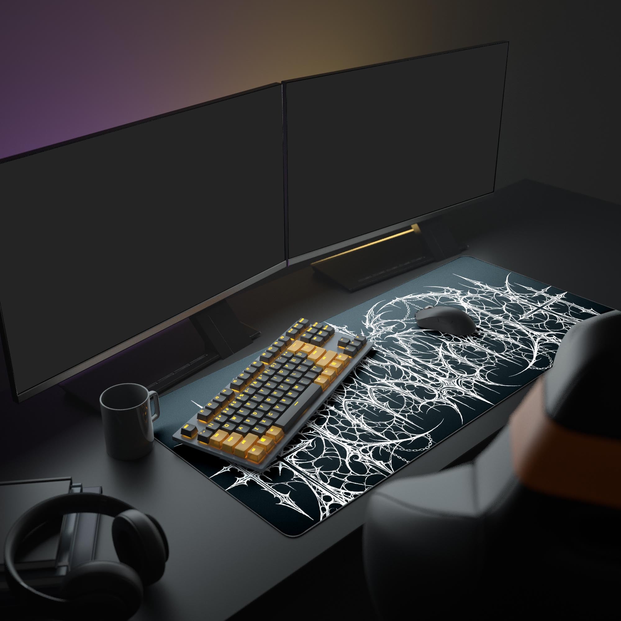 The Gothic Mainframe gaming desk mat shown in a dark PC setup, its intricate white design creating a stark contrast under a monitor and next to a gaming keyboard and mouse. - Epic Design Pads & Mousepads