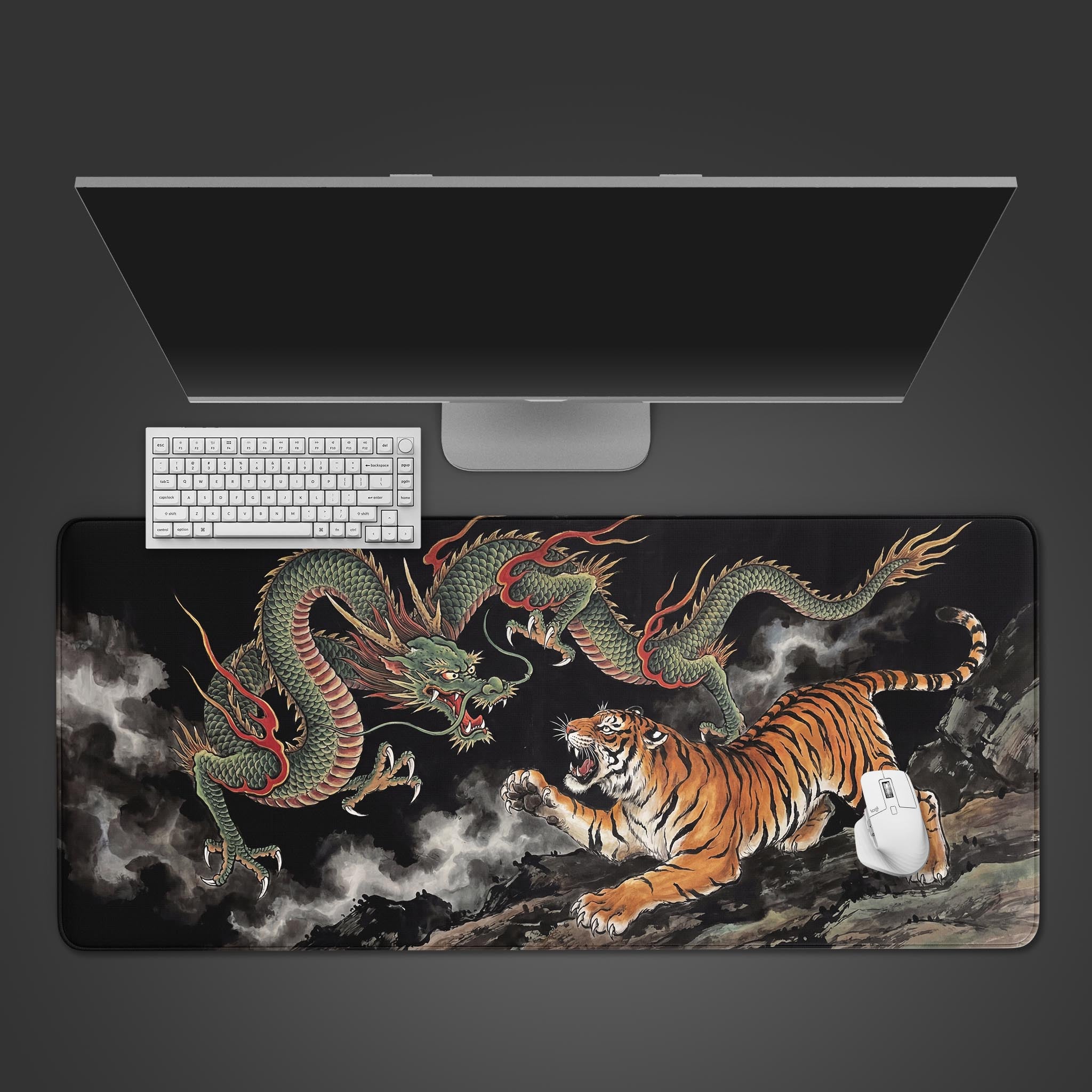 Top-down view of the Heaven and Earth gaming desk mat featuring a dragon vs tiger design, shown with a white keyboard, mouse, and monitor. - Epic Design Pads & Mousepads