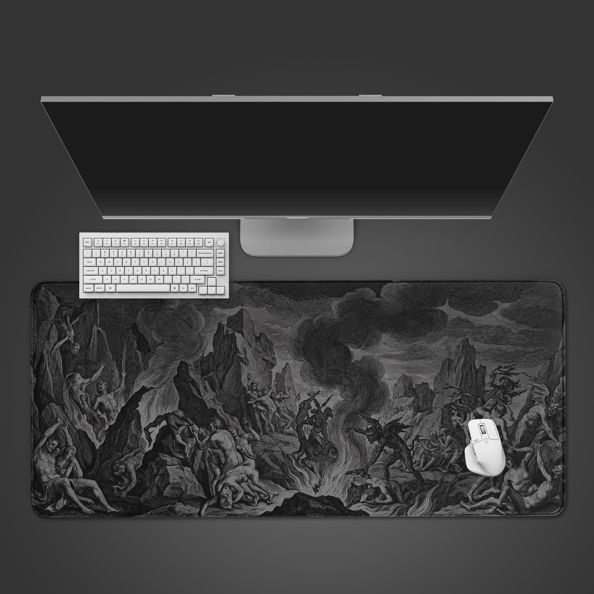 A top-down view of the Infernal Etching gaming desk mat, showing the dark fantasy woodcut design beneath a sleek monitor, white keyboard, and mouse. - Epic Design Pads & Mousepads