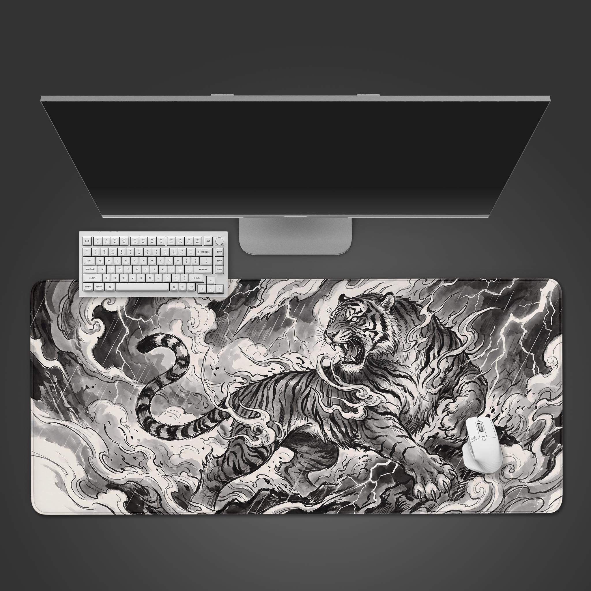 A fierce black and white ink wash tiger roaring amidst swirling clouds and lightning on an extended desk mat.