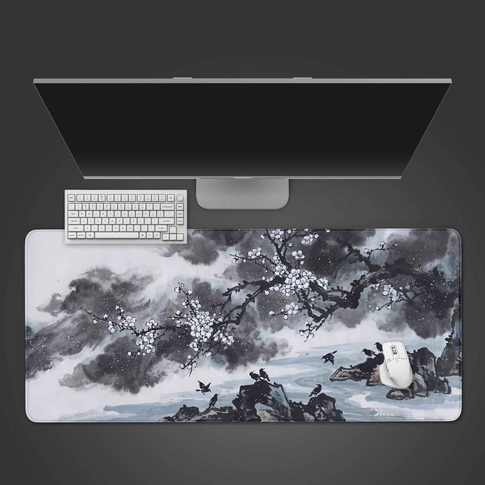 Full view of the desk mat featuring a traditional black and white ink wash painting of blossoms and mountains.