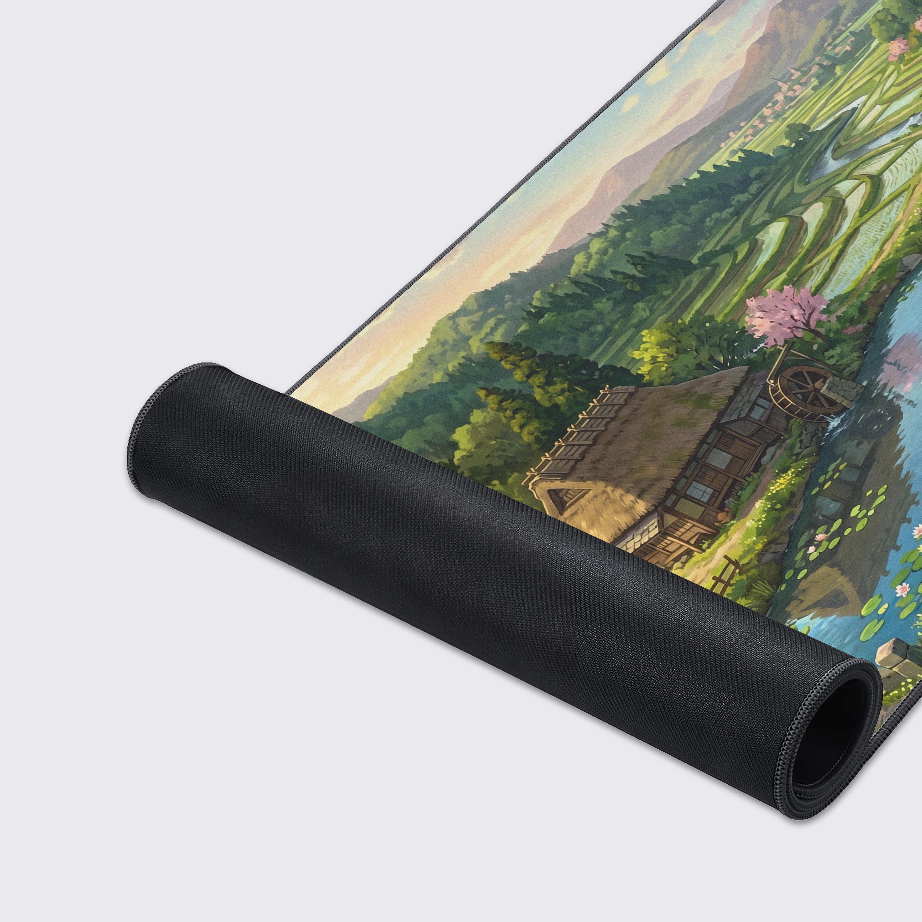 Lush green valley and traditional thatched-roof cottage depicted on a large aesthetic gaming desk mat.