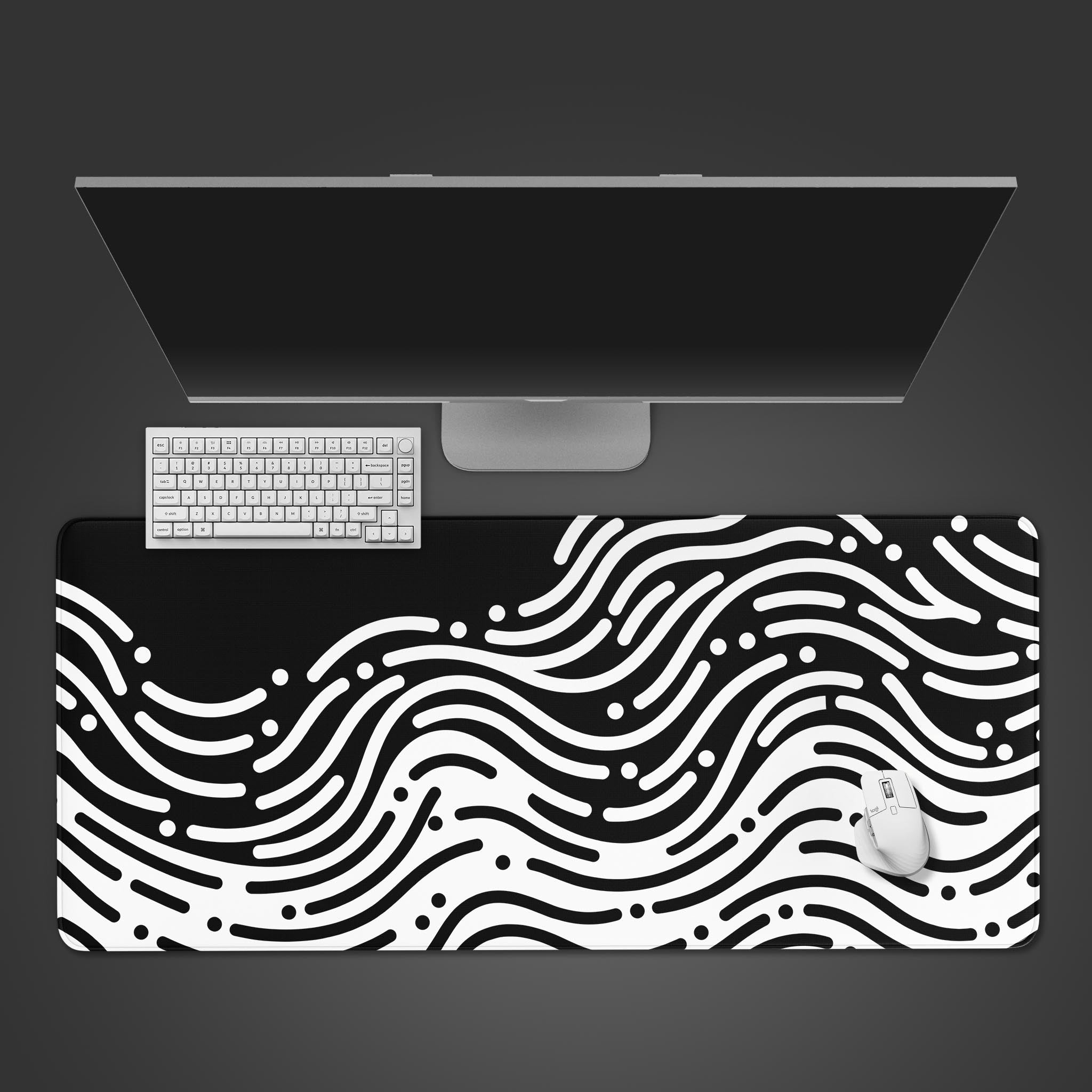 Kinetic Flow desk mat with its black and white abstract wave design. Shown from a top-down view with a sleek keyboard and mouse, creating a focused, minimalist workspace. - Epic Design Pads & Mousepads