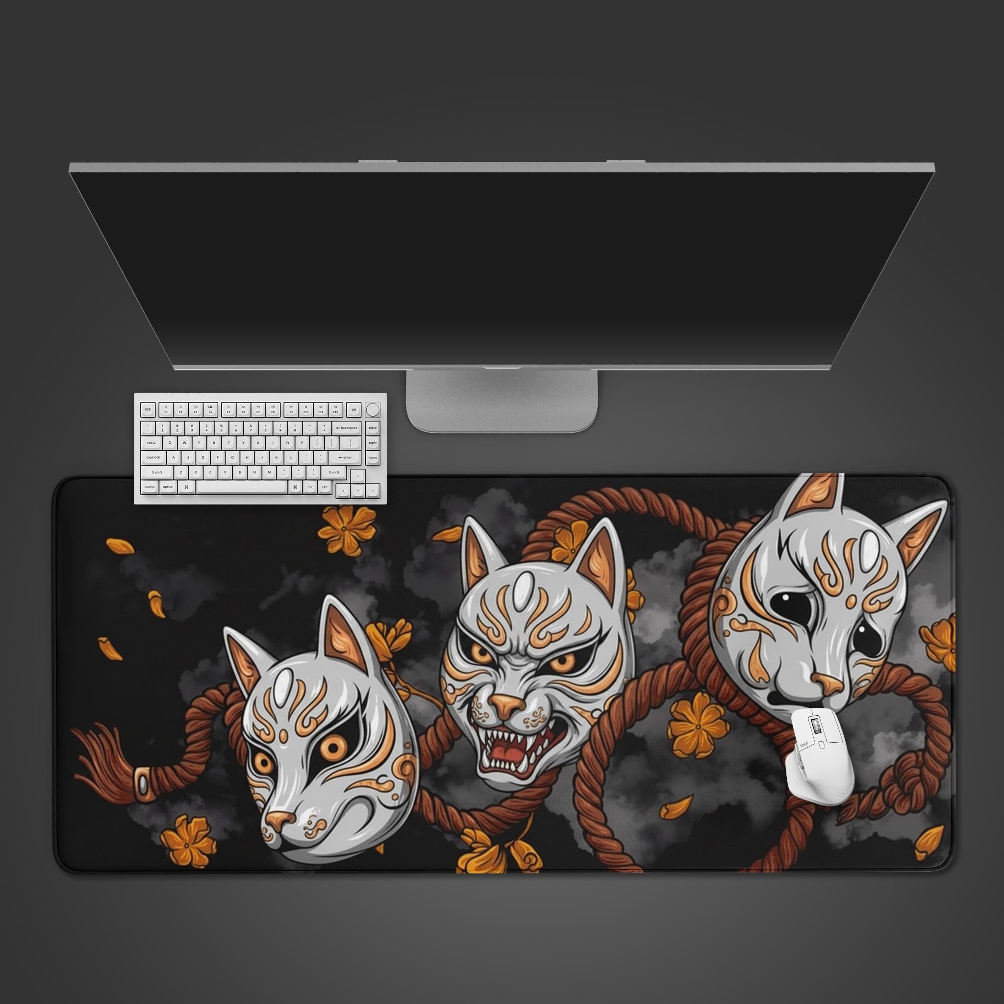 Kitsune Spirit desk mat with Japanese fox masks and floral accents – shown with keyboard and mouse on desktop. - Epic Design Pads