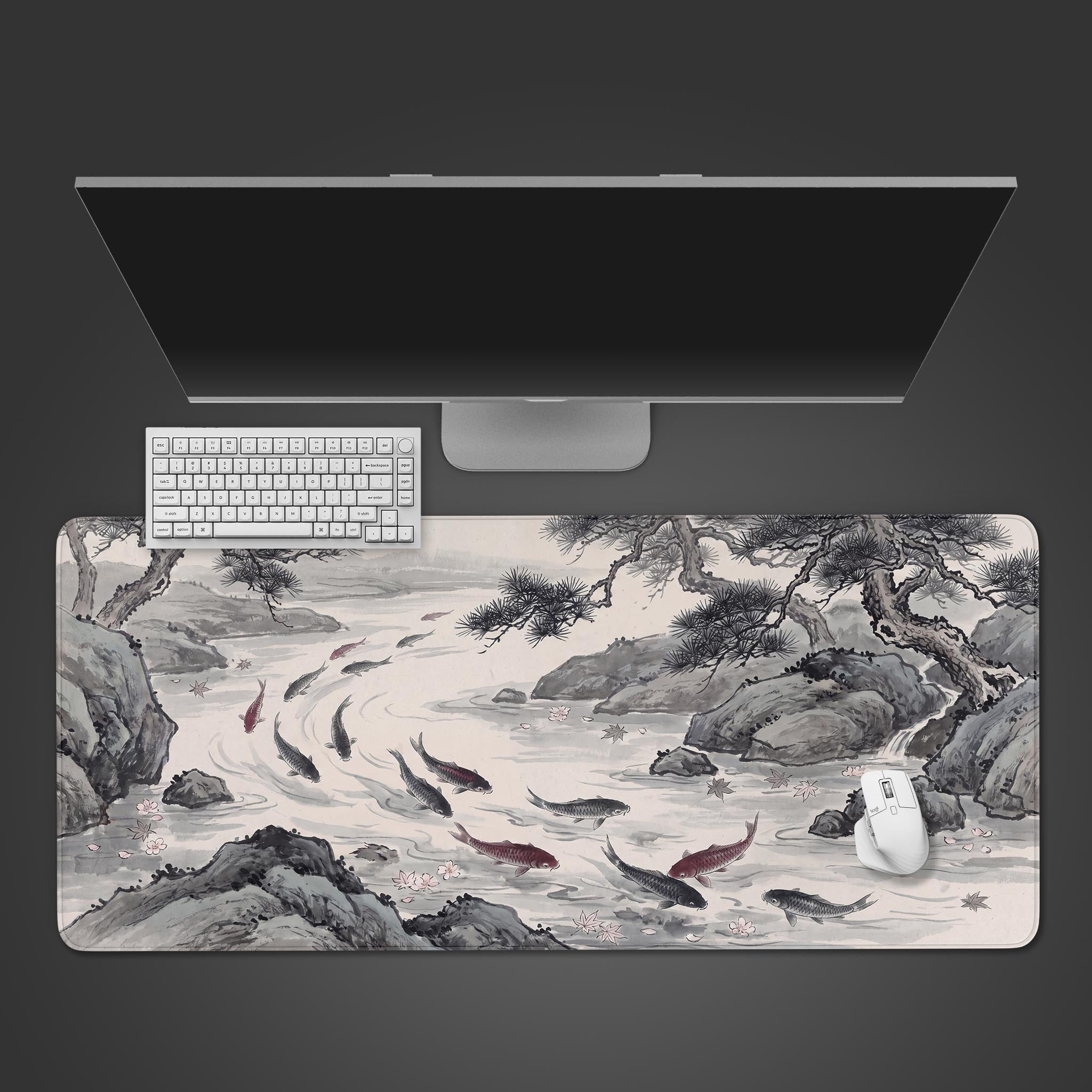 A wide desk mat featuring a traditional ink wash painting of koi fish swimming in a river