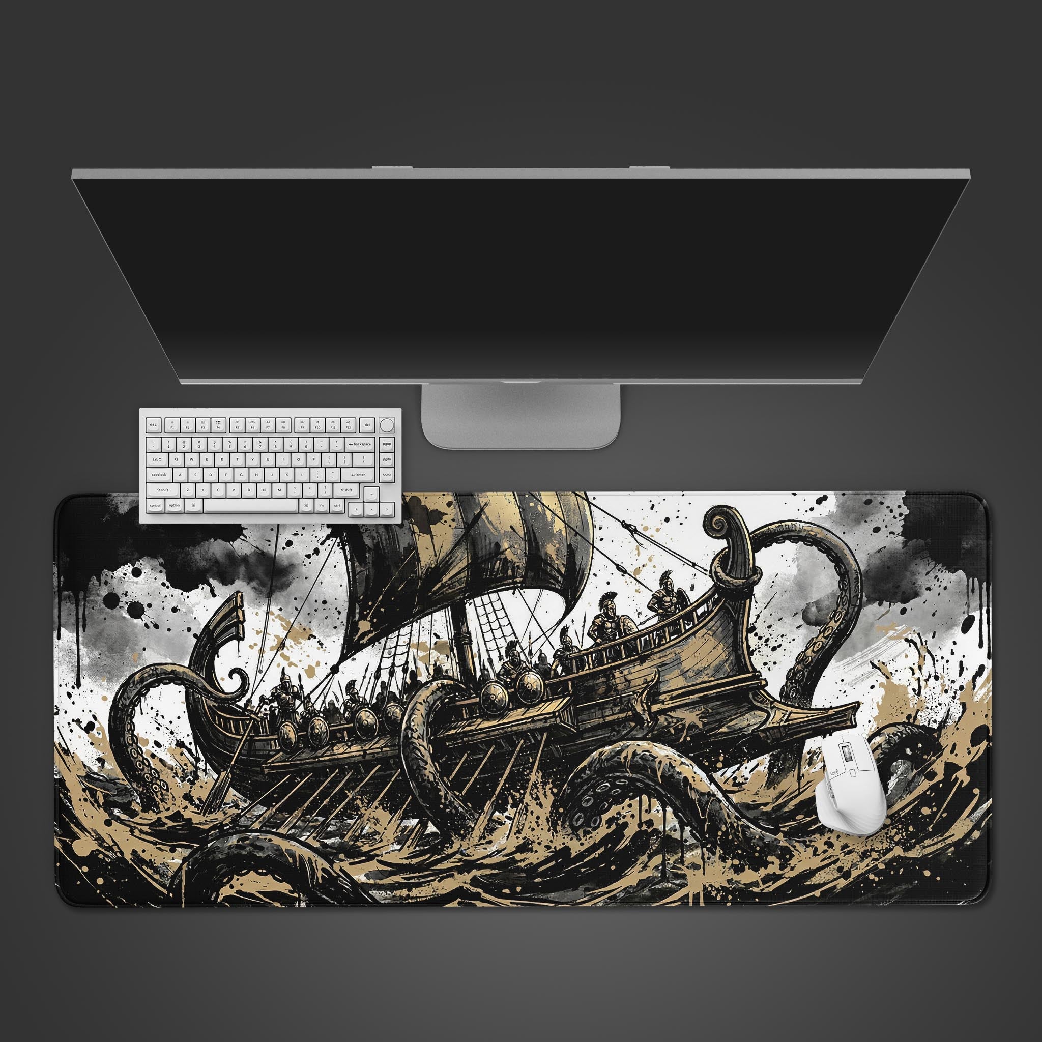 Top-down view of the Kraken's Grasp gaming desk mat, featuring a mythological sea battle. A white keyboard and mouse are shown on the mat beneath a large monitor. - Epic Design Pads & Mousepads