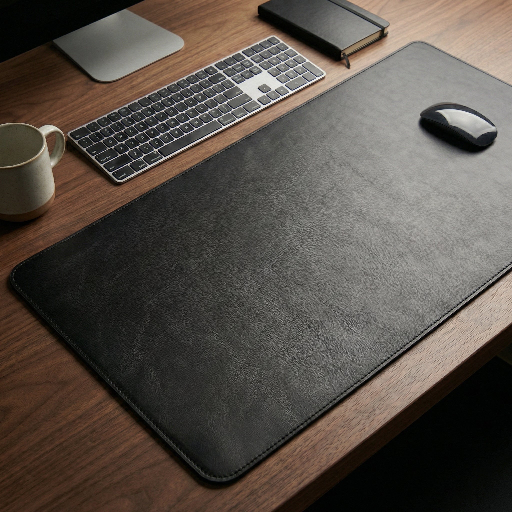 Leather desk pad showcasing executive style – desktop view with keyboard and mouse.