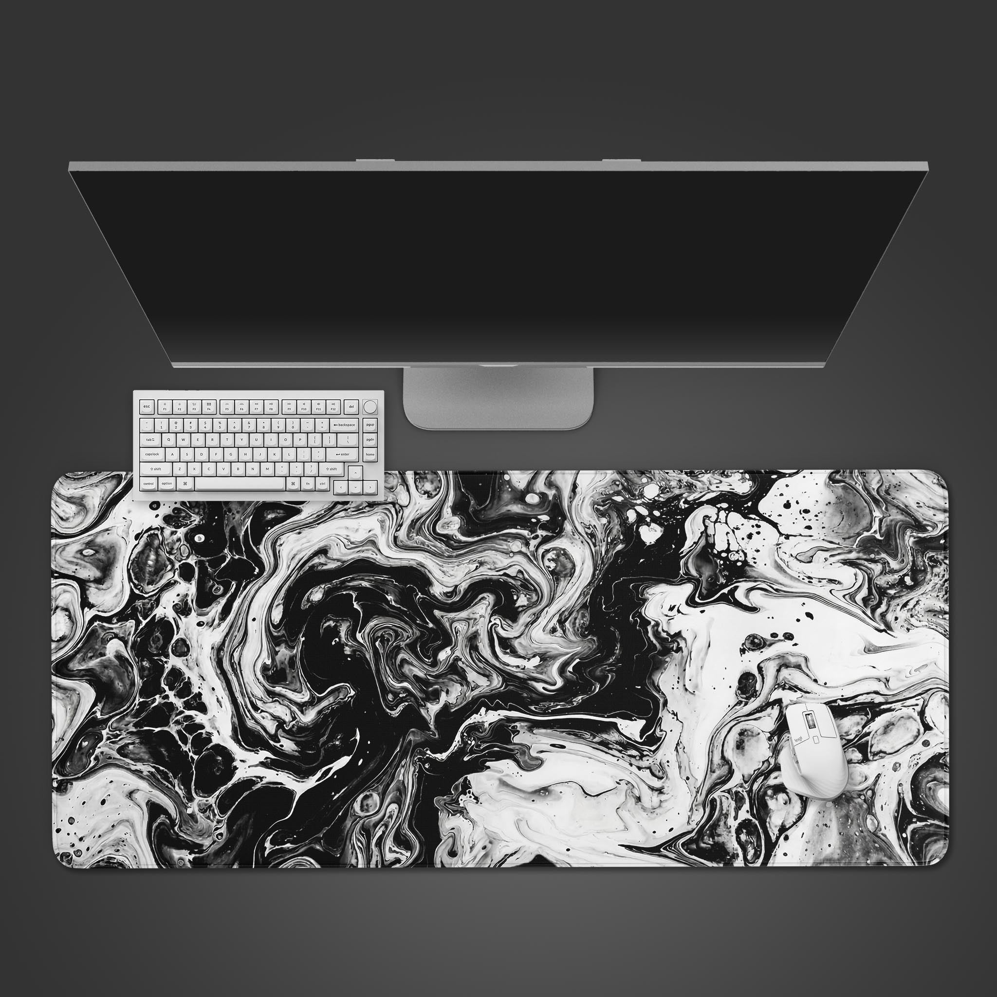 Top-down view of the Liquid Abyss gaming desk mat, featuring its black and white marble design with a white keyboard, mouse, and monitor on a dark background. - Epic Design Pads & Mousepads