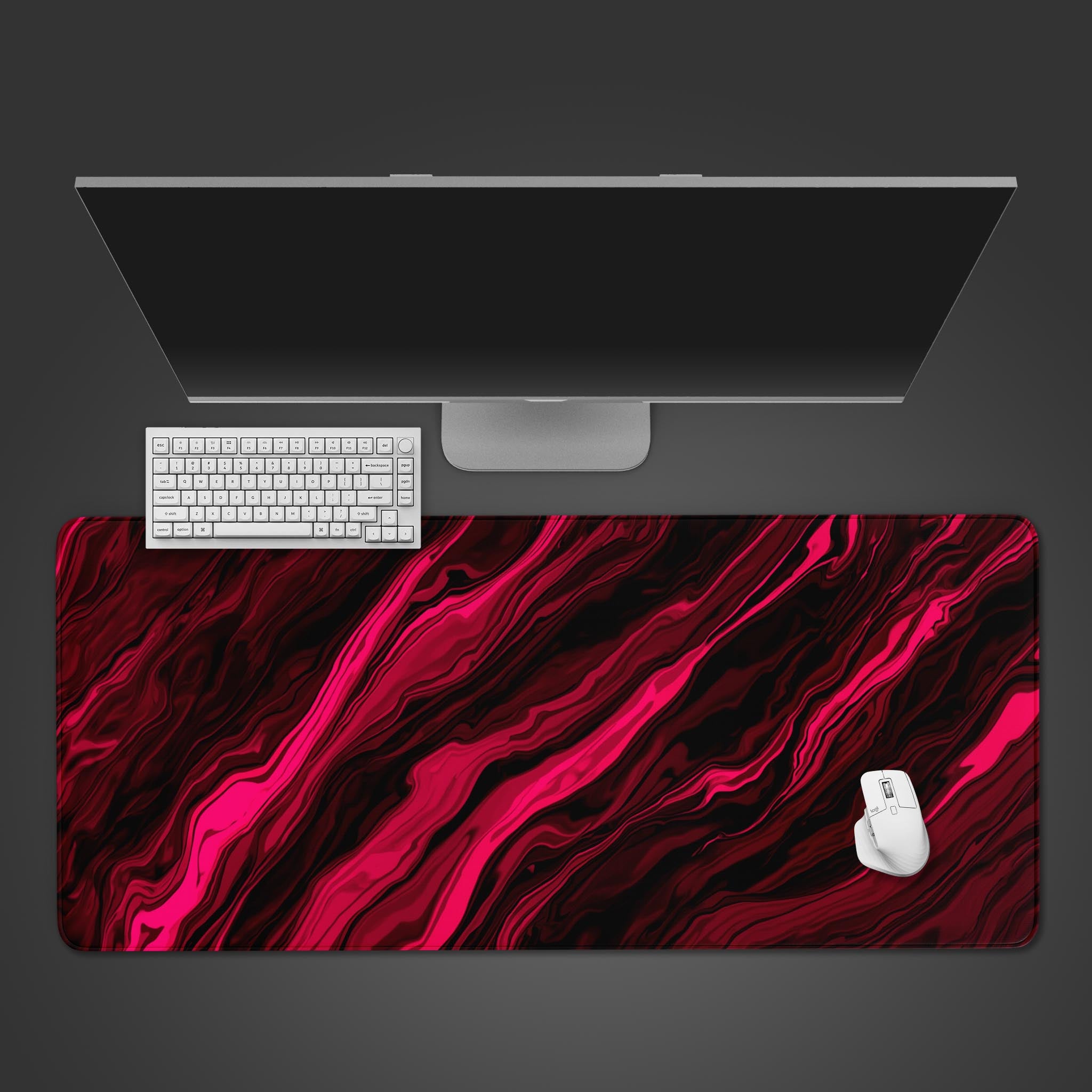 Liquid Red abstract art desk mat with a swirling red and black design, shown from a top-down desktop view with a gaming keyboard and mouse. - Epic Design Pads
