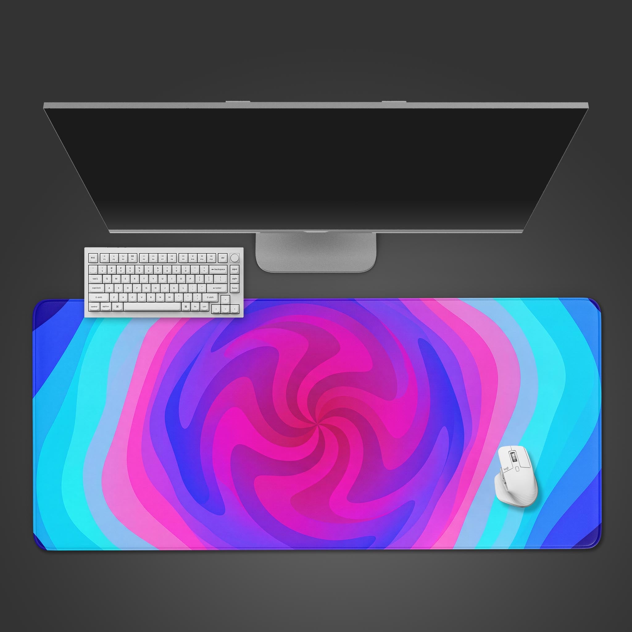 Top-down view of the Lucid Spiral gaming desk mat, featuring its vibrant pink and blue swirl design, with a white keyboard and mouse. - Epic Design Pads & Mousepads