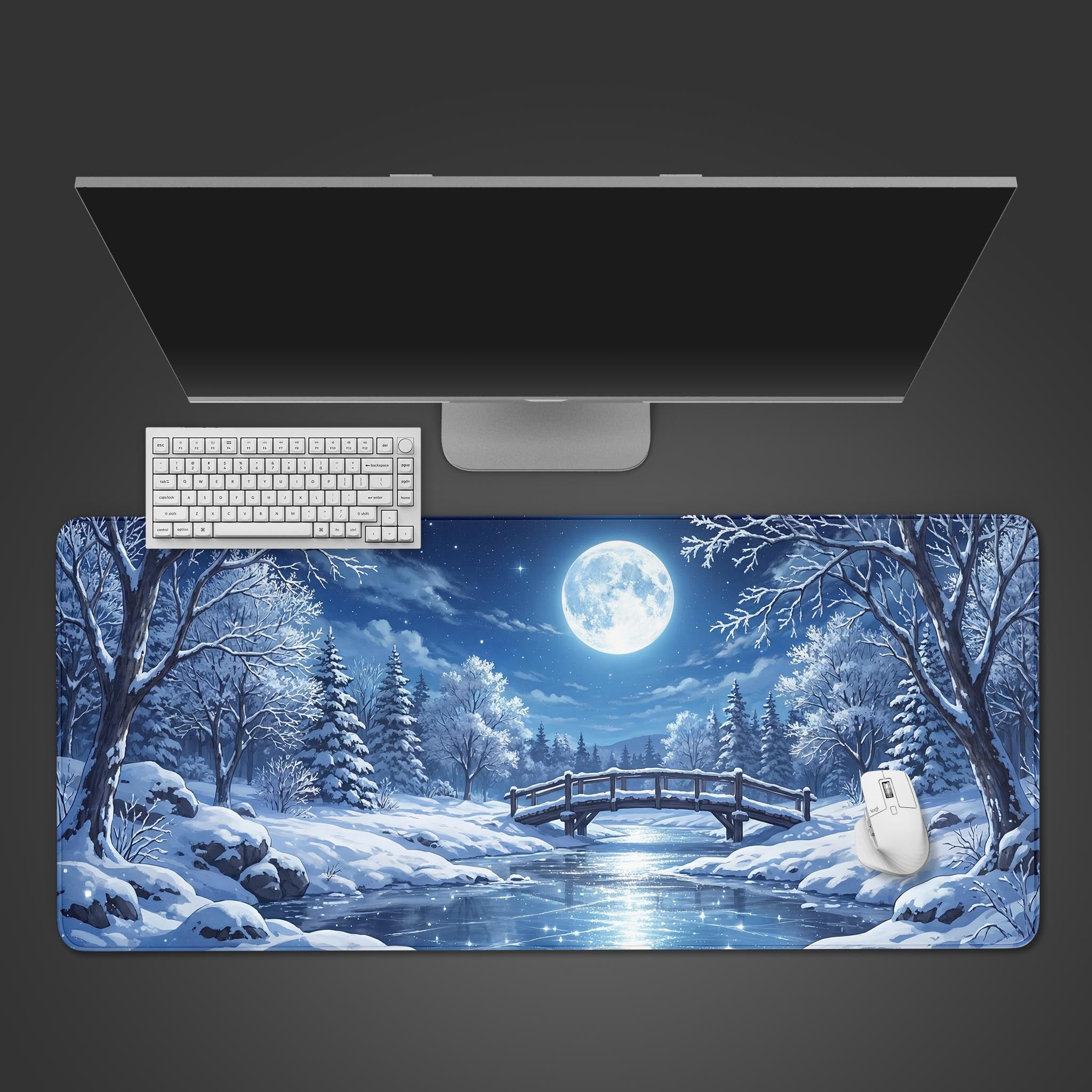Top-down view of the Lunar Frost gaming desk mat, showing its winter moon design beneath a white keyboard, mouse, and a large monitor. - Epic Design Pads & Mousepads