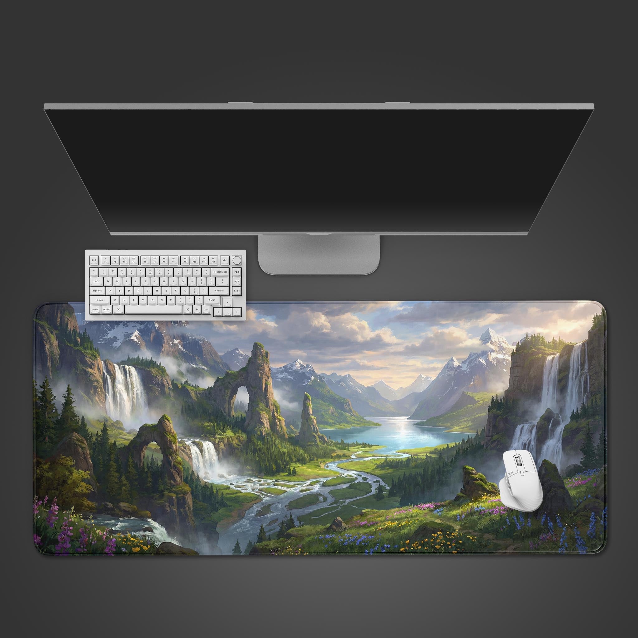 Top-down view of the Majestic Valley gaming desk mat featuring an epic fantasy landscape, shown with a white keyboard and mouse under a sleek monitor. - Epic Design Pads & Mousepads