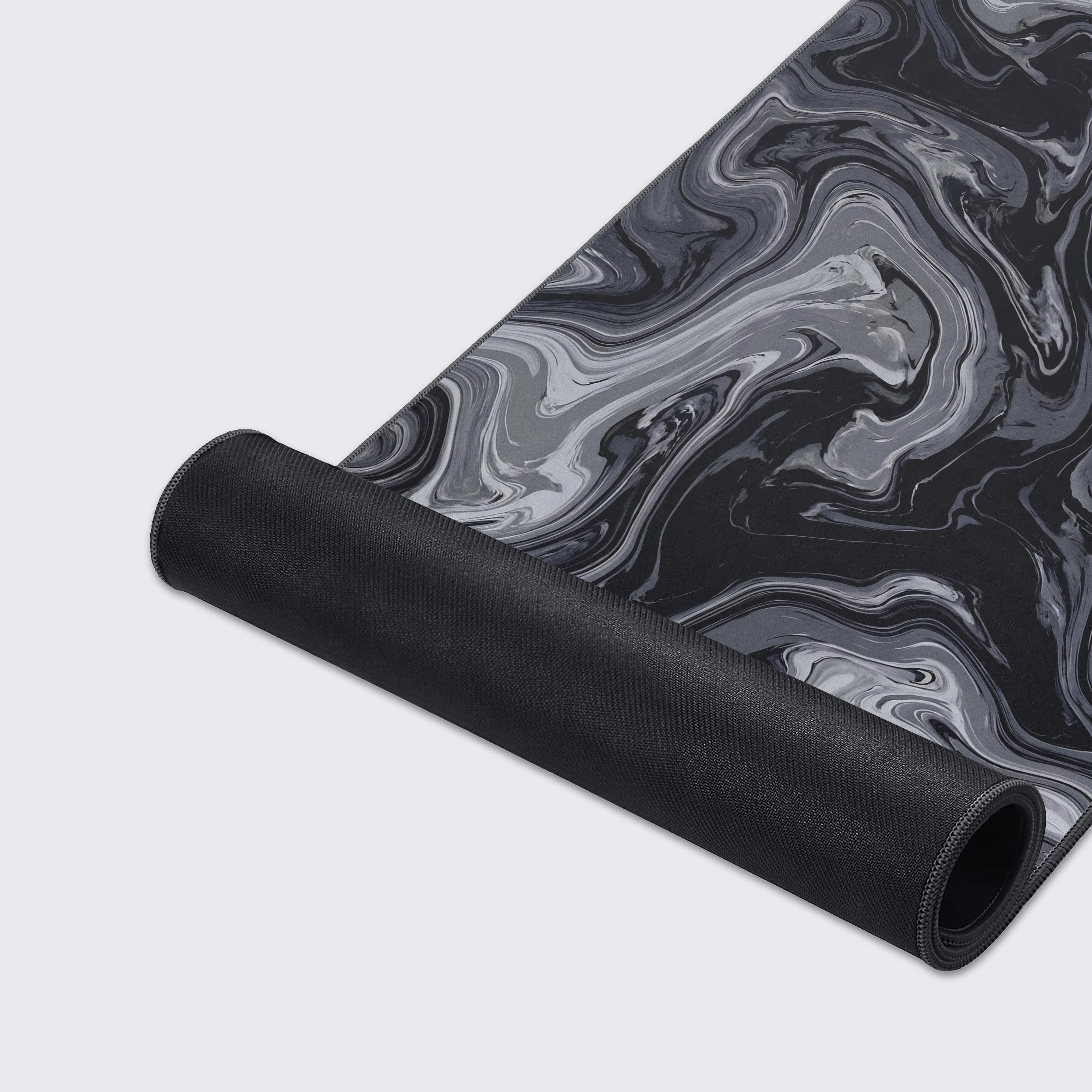Close-up of the smooth water-proof surface on the dark abstract desk mat