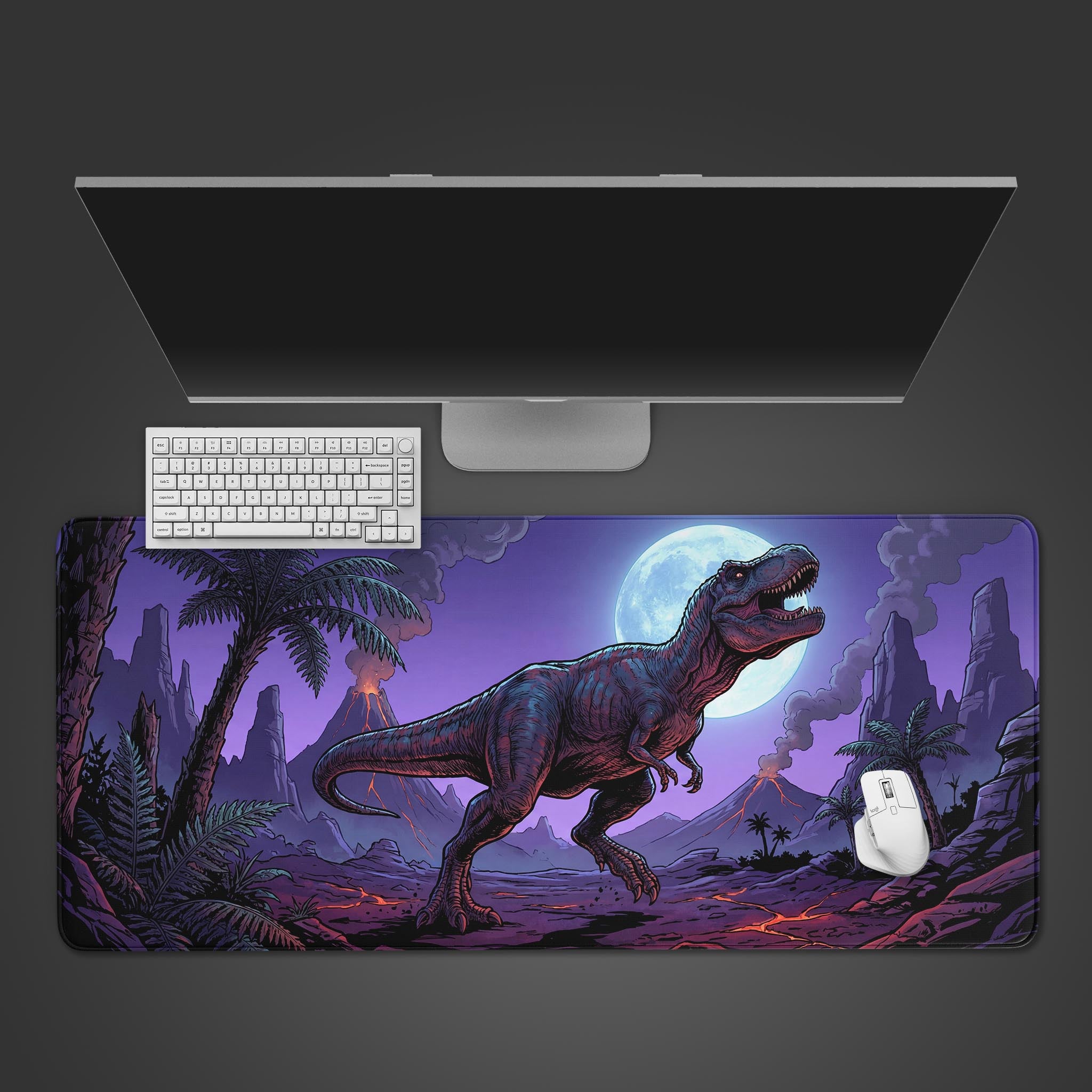 The Midnight Apex gaming desk mat shown from above with a white keyboard and mouse, featuring a dramatic T-Rex and volcano design under a full moon. - Epic Design Pads & Mousepads