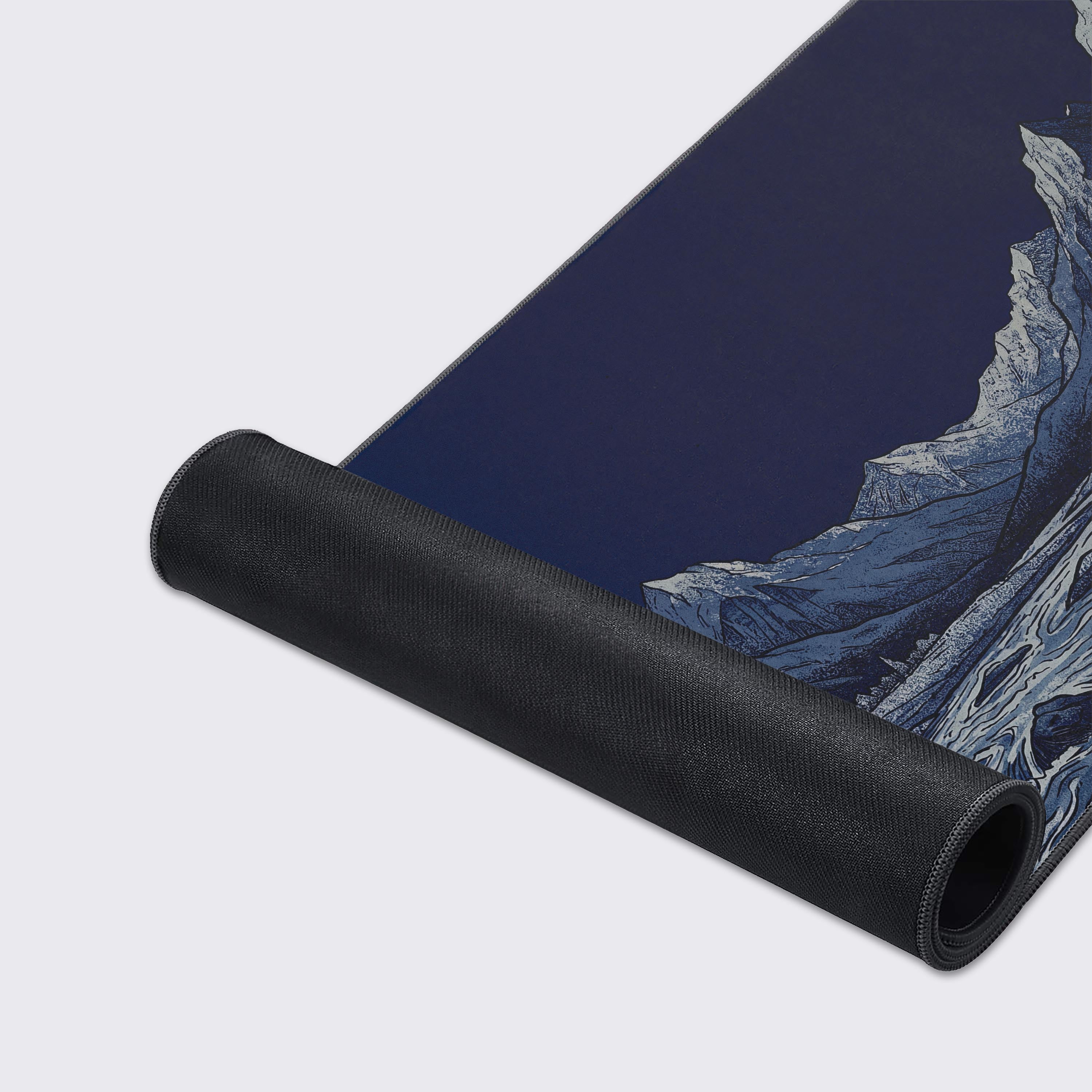 Epic dark blue and grey nature design on an extended gaming desk mat.