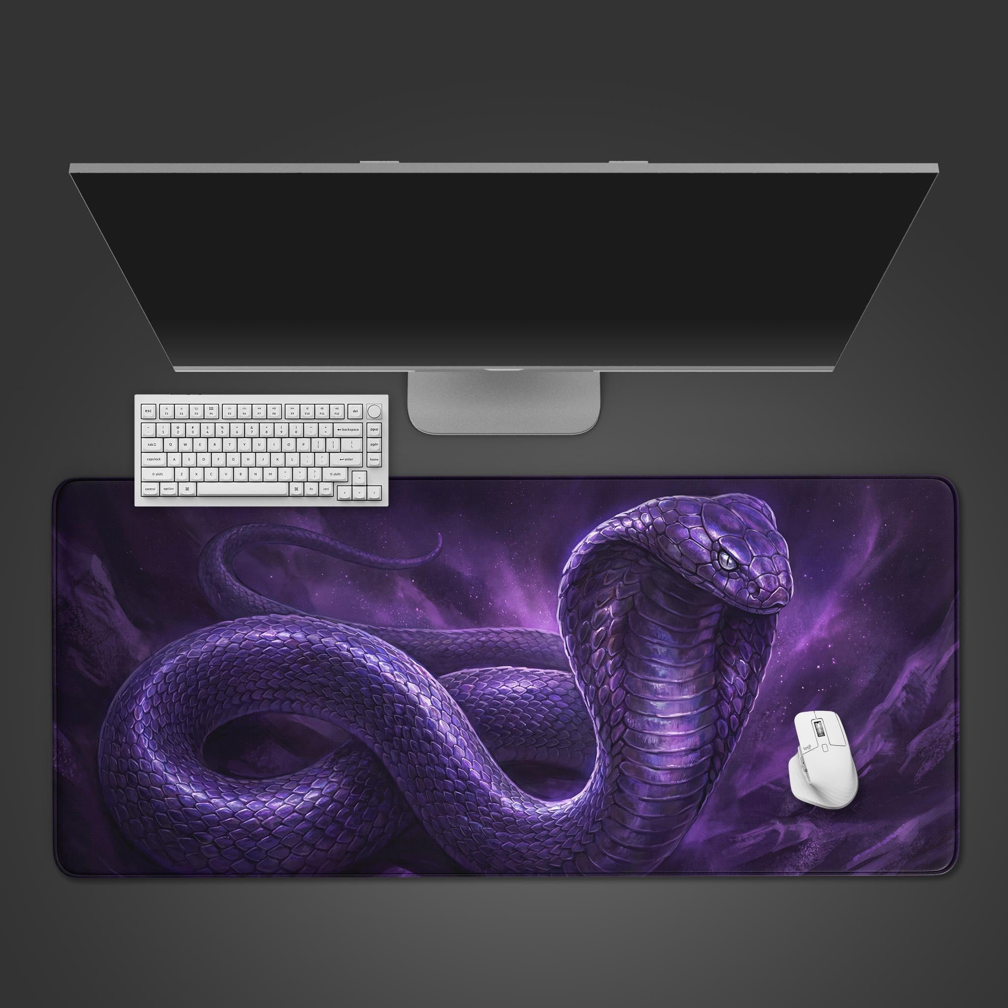 A top-down view of the Nebula Cobra gaming desk mat, featuring a purple cosmic serpent, with a white keyboard and mouse on top. - Epic Design Pads & Mousepads