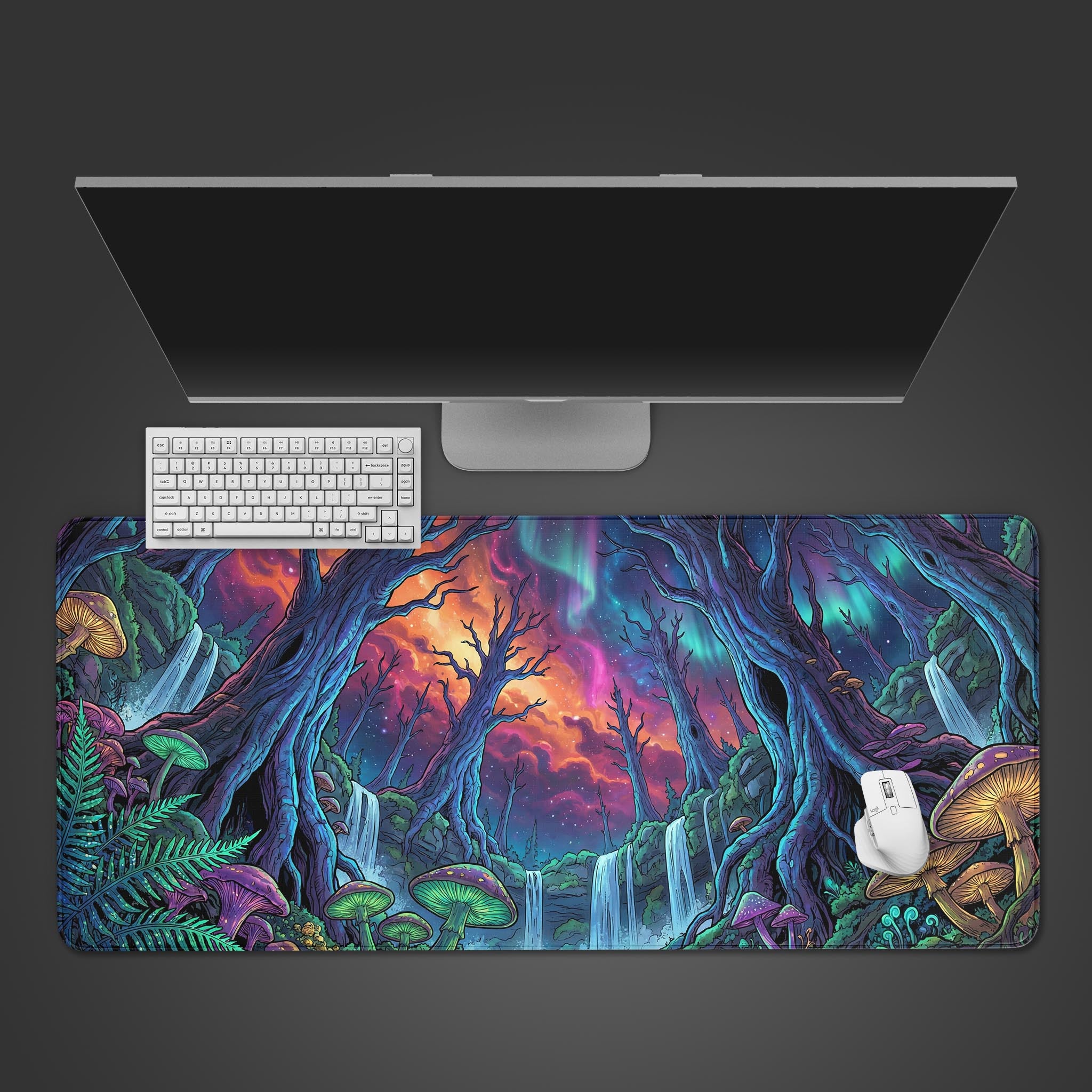 Top-down view of the Nebula Forest gaming desk mat on a desk, accompanied by a sleek white keyboard, mouse, and a widescreen monitor. - Epic Design Pads & Mousepads
