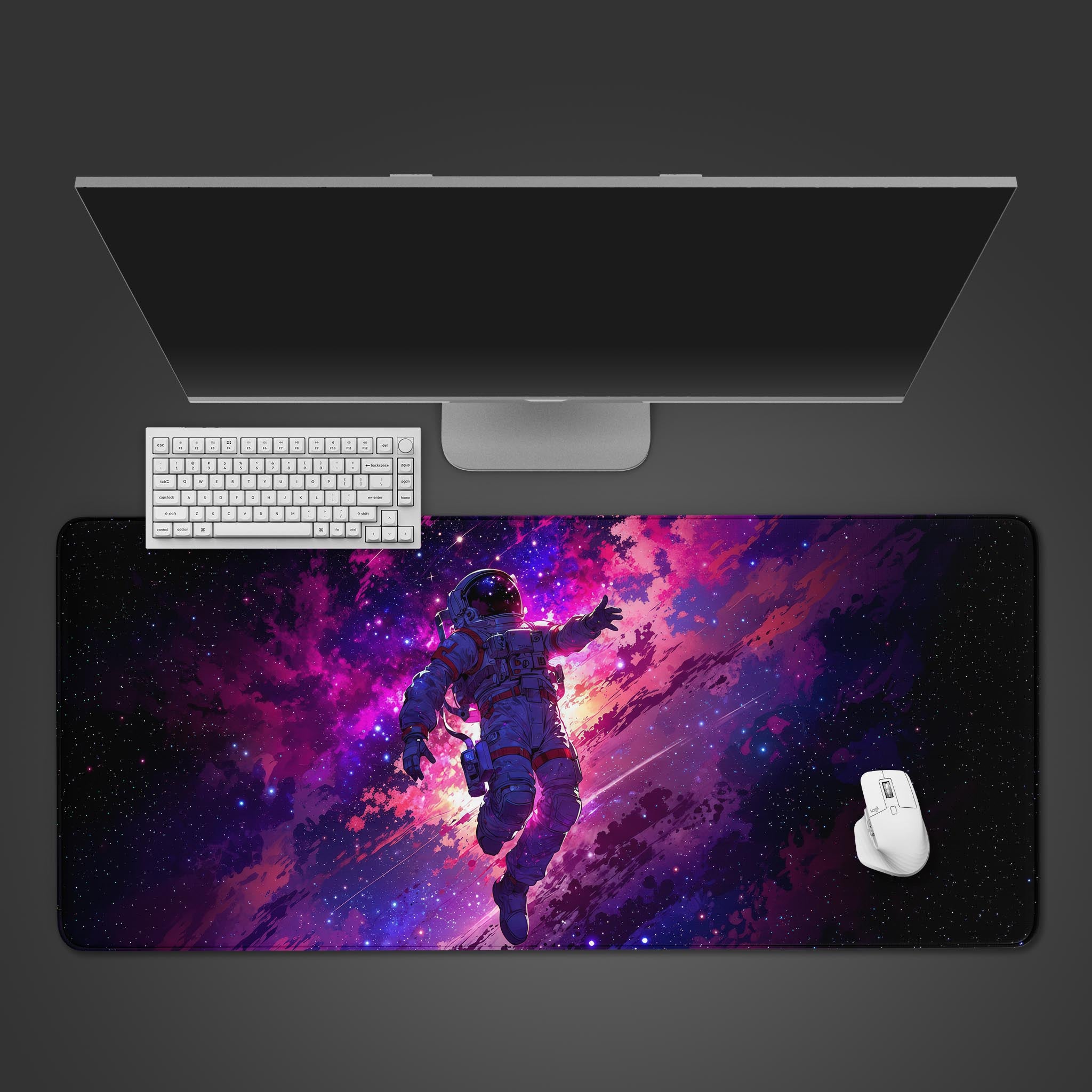 Nebula Navigator space desk mat with astronaut design – top-down view on a desk with a white keyboard and mouse. - Epic Design Pads