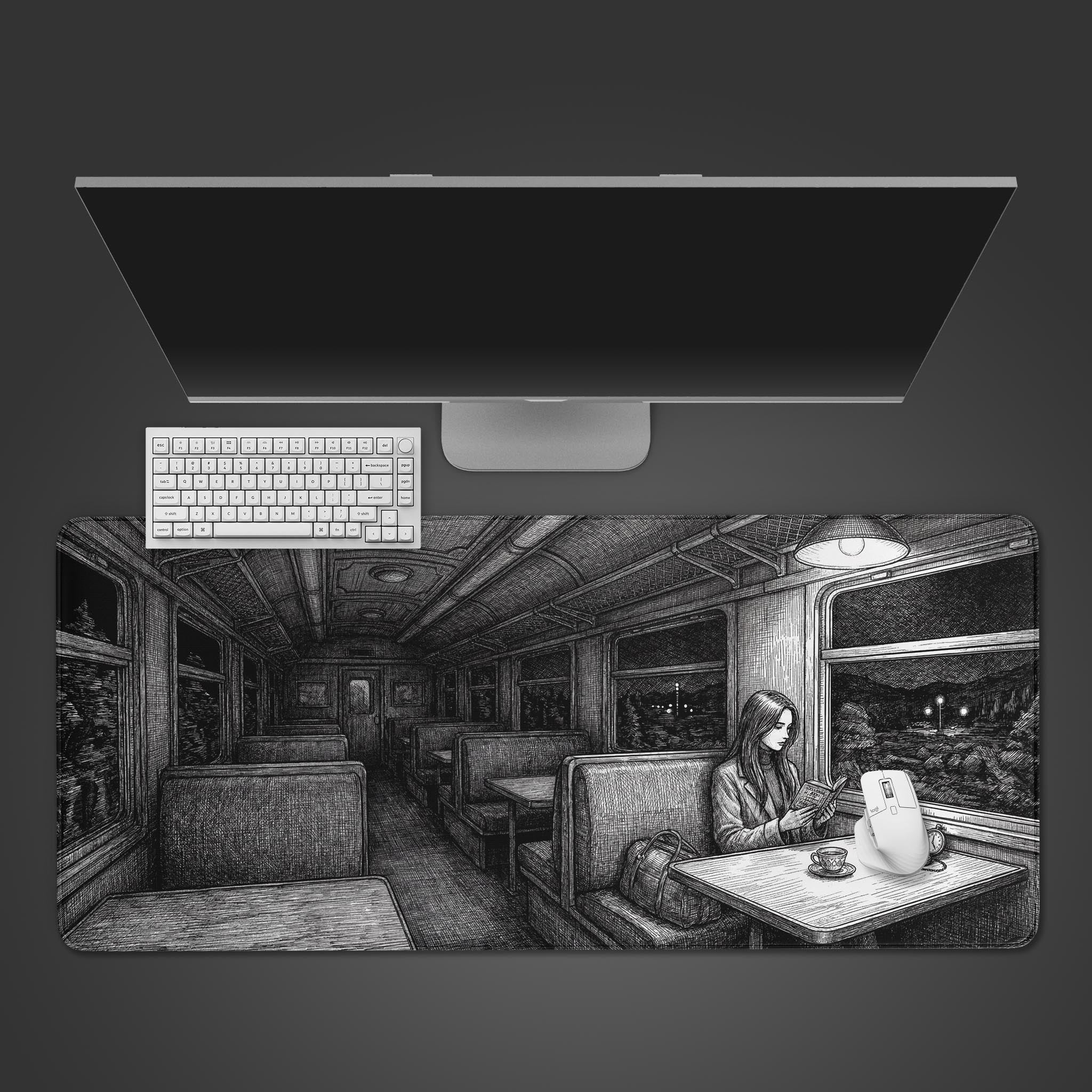 Top-down view of the Night Train desk mat with a white keyboard and mouse. The monochrome design shows a woman reading in a vintage train car. - Epic Design Pads & Mousepads