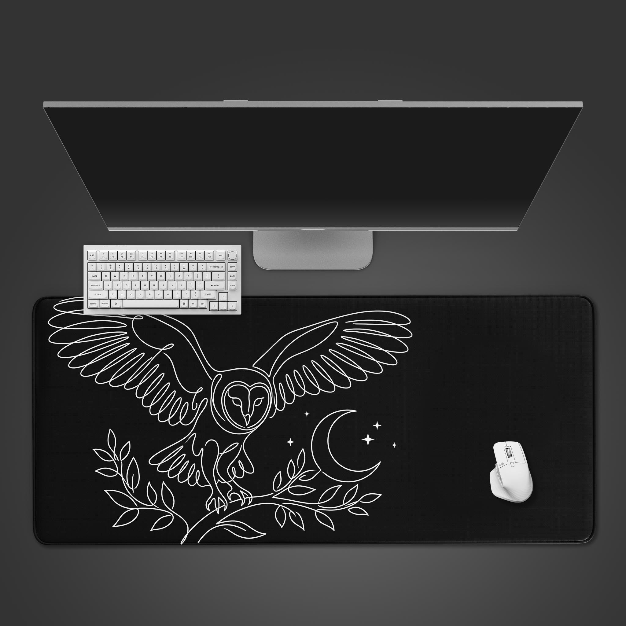 A top-down view of the Nocturnal Focus gaming desk mat, featuring a white line art owl, with a white keyboard and mouse on a dark background. - Epic Design Pads & Mousepads