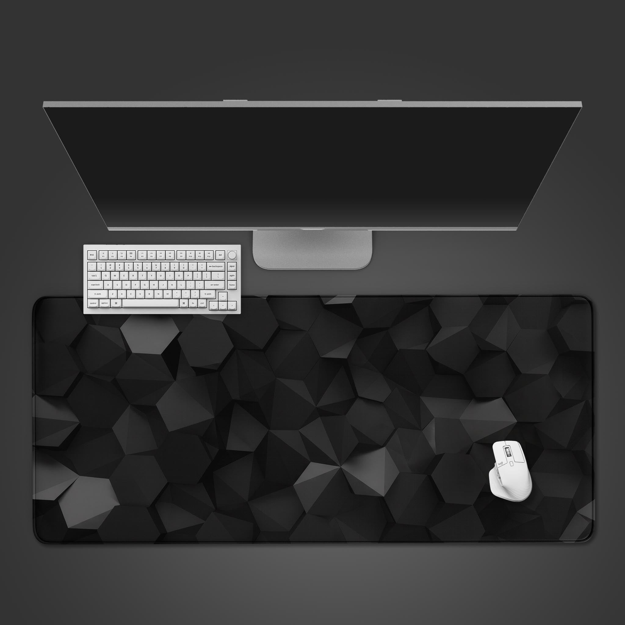 Obsidian Facets geometric desk mat with 3D pattern – top-down view with a modern black keyboard and wireless mouse. - Epic Design Pads