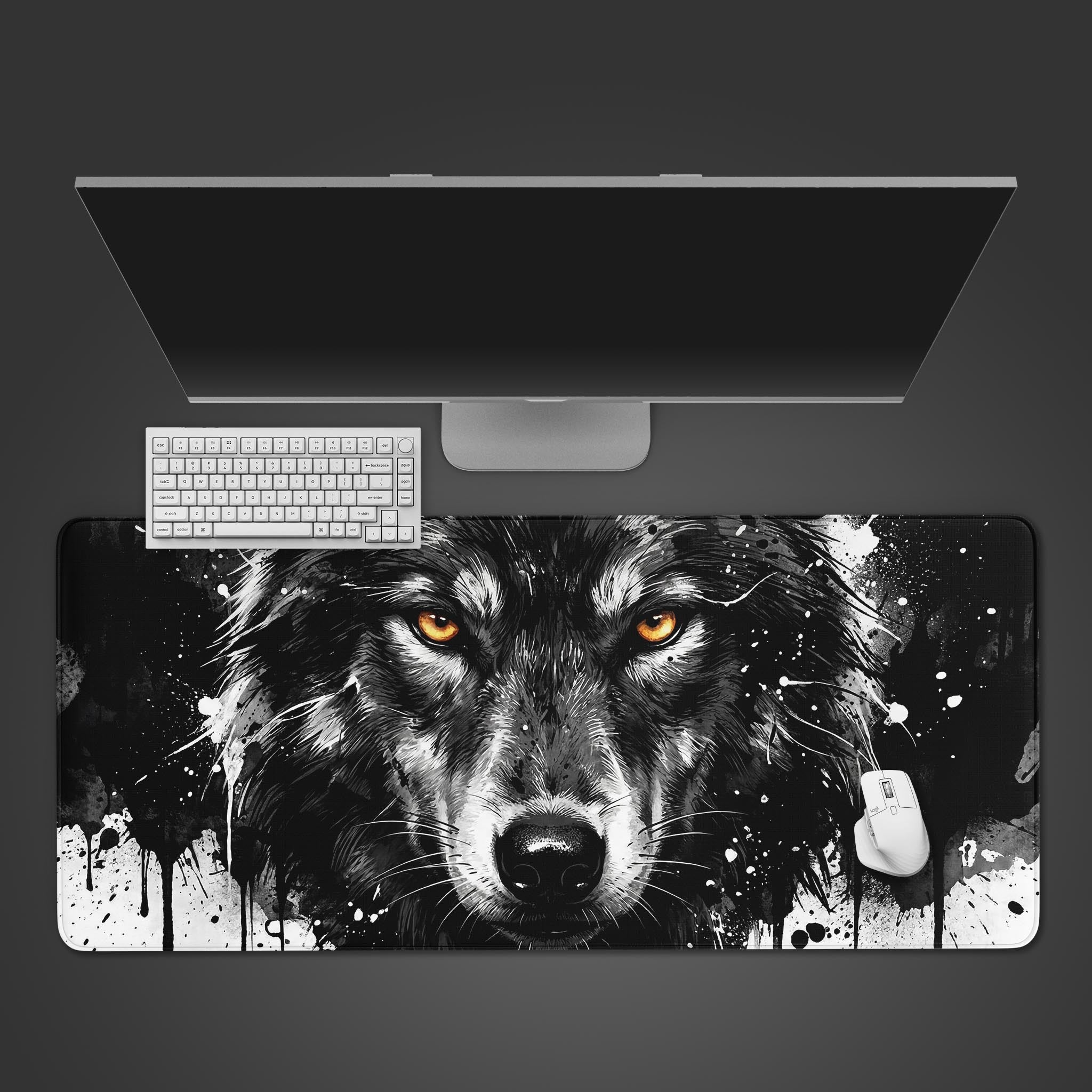 Top-down view of the Primal Gaze wolf design gaming desk mat, shown with a white keyboard, mouse, and a large monitor on a dark surface. - Epic Design Pads & Mousepads