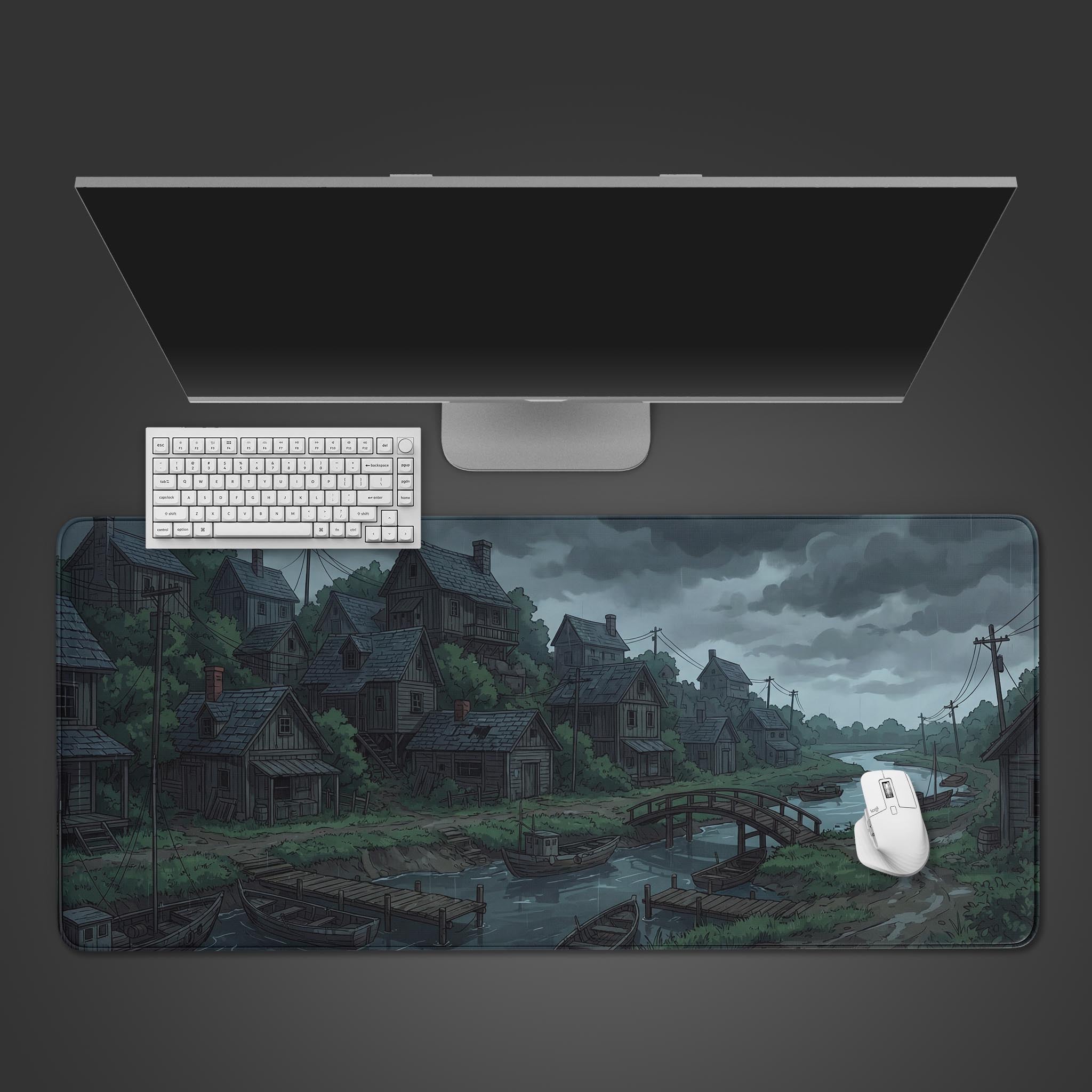 Top-down view of the Rainbound Harbor gaming desk mat, showing the somber fishing village art alongside a modern keyboard, mouse, and monitor. - Epic Design Pads & Mousepads