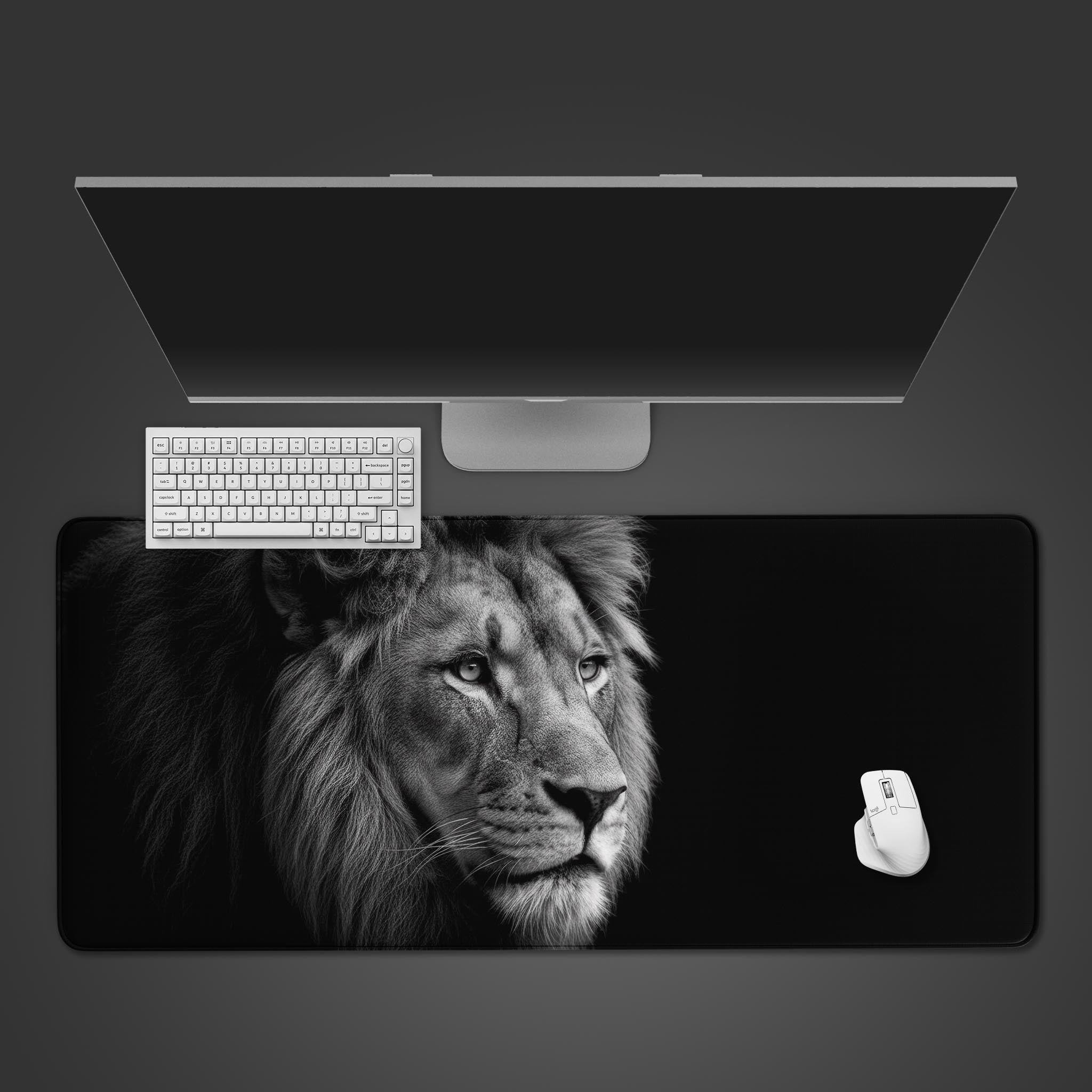 Regal Gaze lion desk mat in black and white shown in a top-down desktop view with a keyboard and mouse, showcasing its large size. - Epic Design Pads