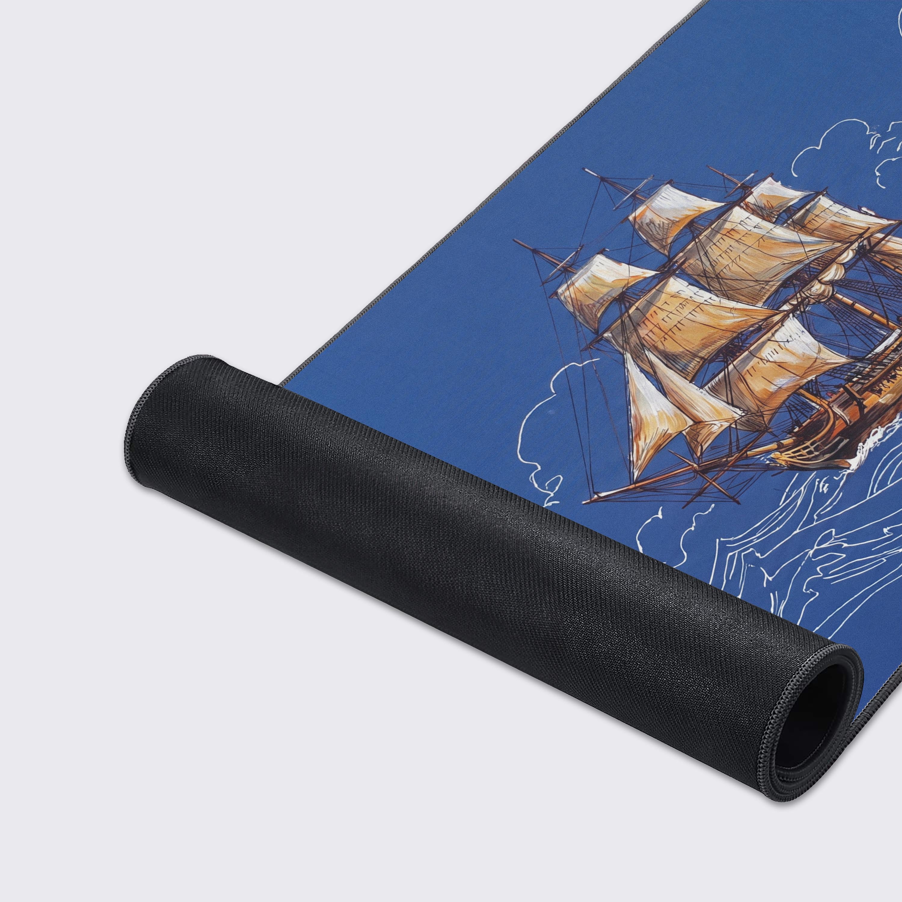 Front view of a nautical themed desk mat showing a galleon ship sailing on sketched ocean waves.