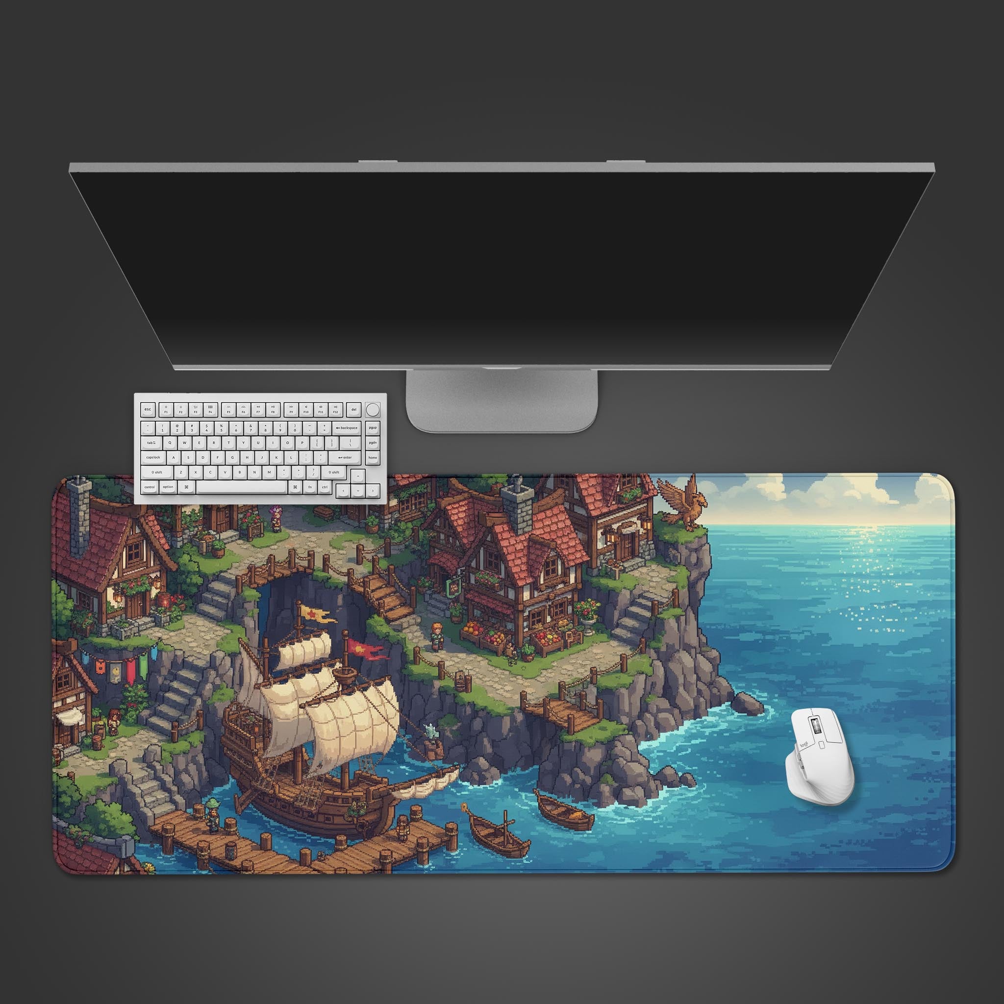 Seaside Village pixel art desk mat with a charming coastal town design, shown on a desk with a white keyboard and mouse from a top-down view. - Epic Design Pads