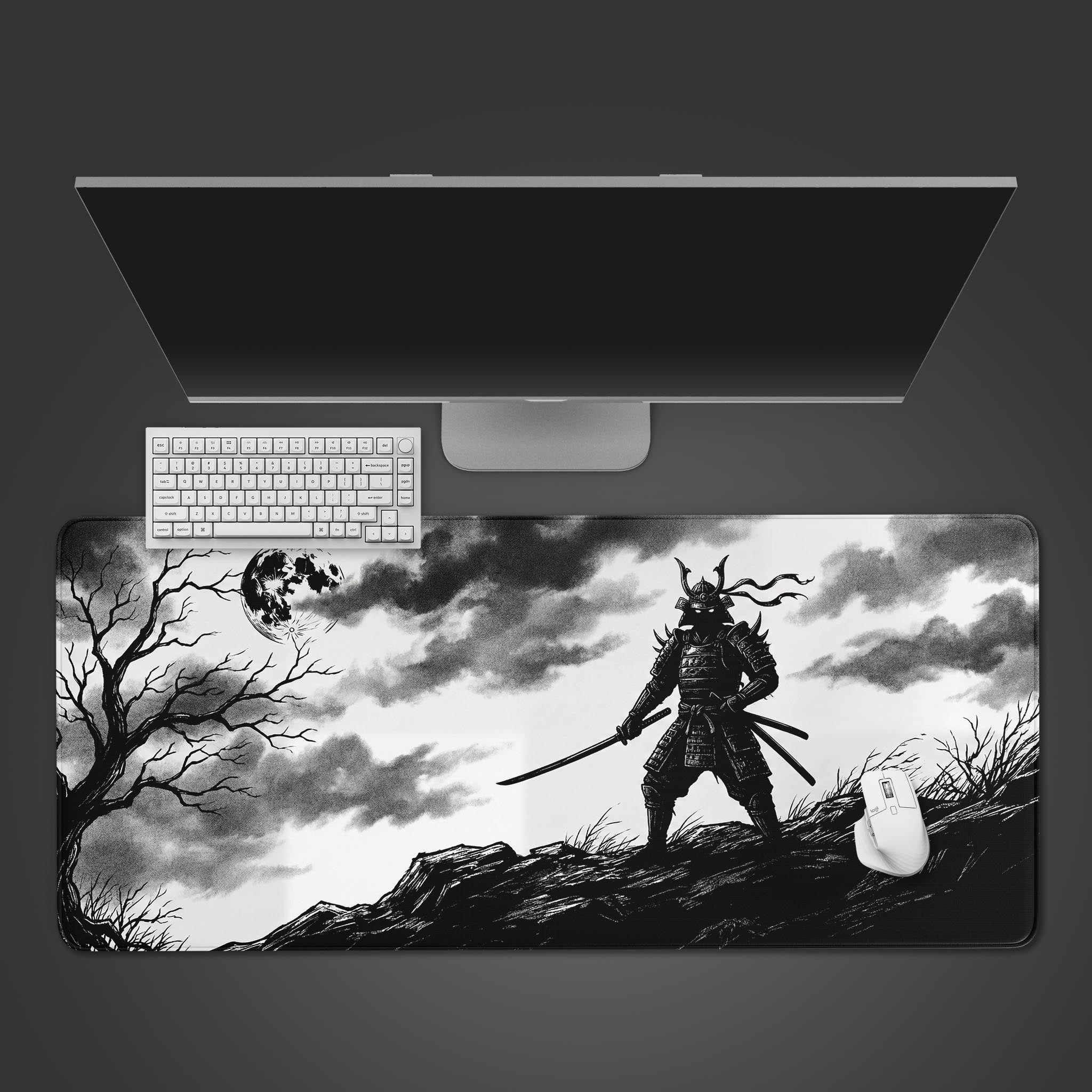 A top-down view of the Shadow Samurai gaming desk mat, featuring a monochrome Japanese warrior design, with a white keyboard and mouse placed on top. - Epic Design Pads & Mousepads