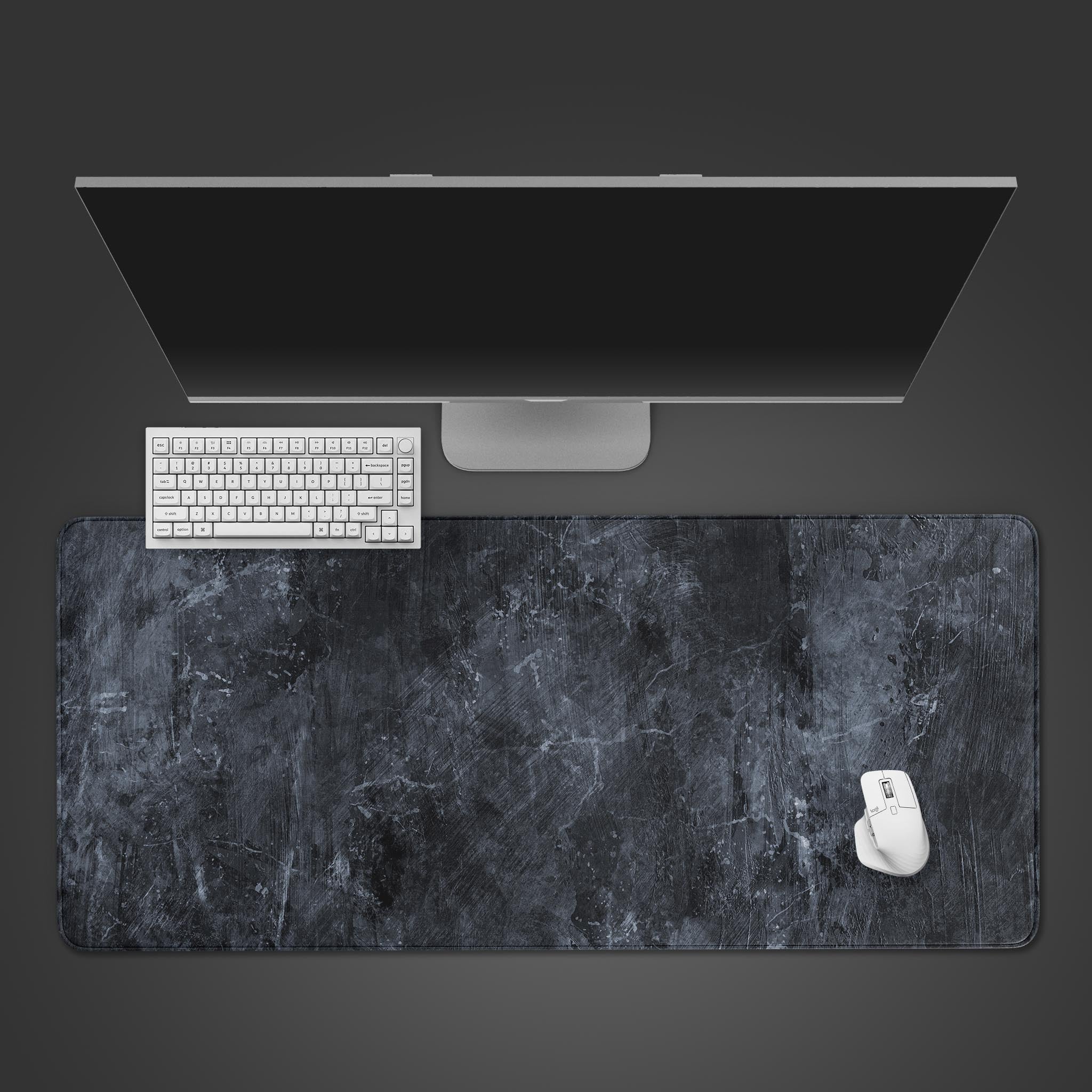 Shadow Slate gray desk mat with a dark concrete texture, shown from a top-down view with a black keyboard and wireless mouse. - Epic Design Pads & Mousepads