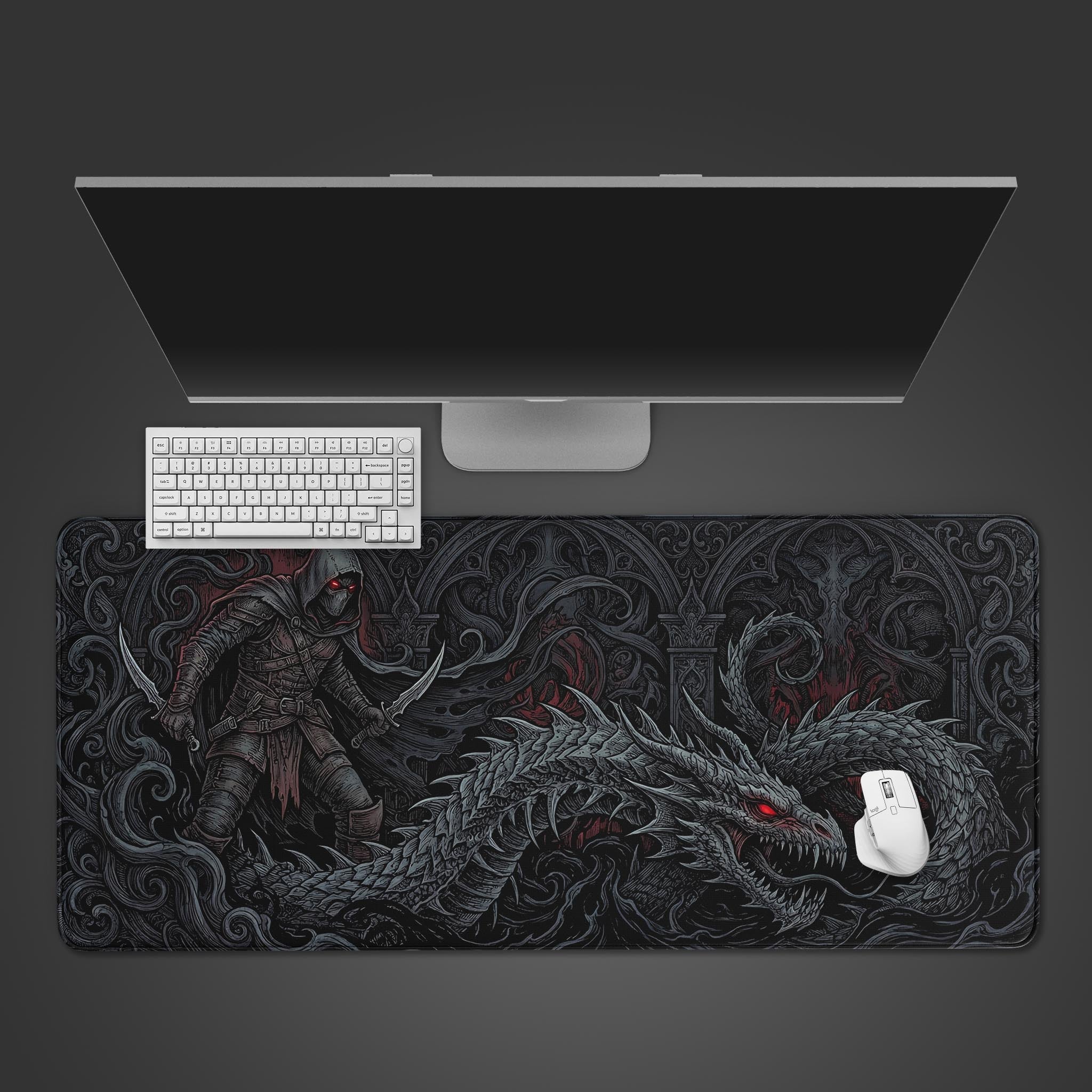 Top-down view of the Shadowborn Hunter gaming desk mat featuring a dark fantasy dragon and rogue design, shown with a white keyboard and mouse on a dark desk. - Epic Design Pads & Mousepads