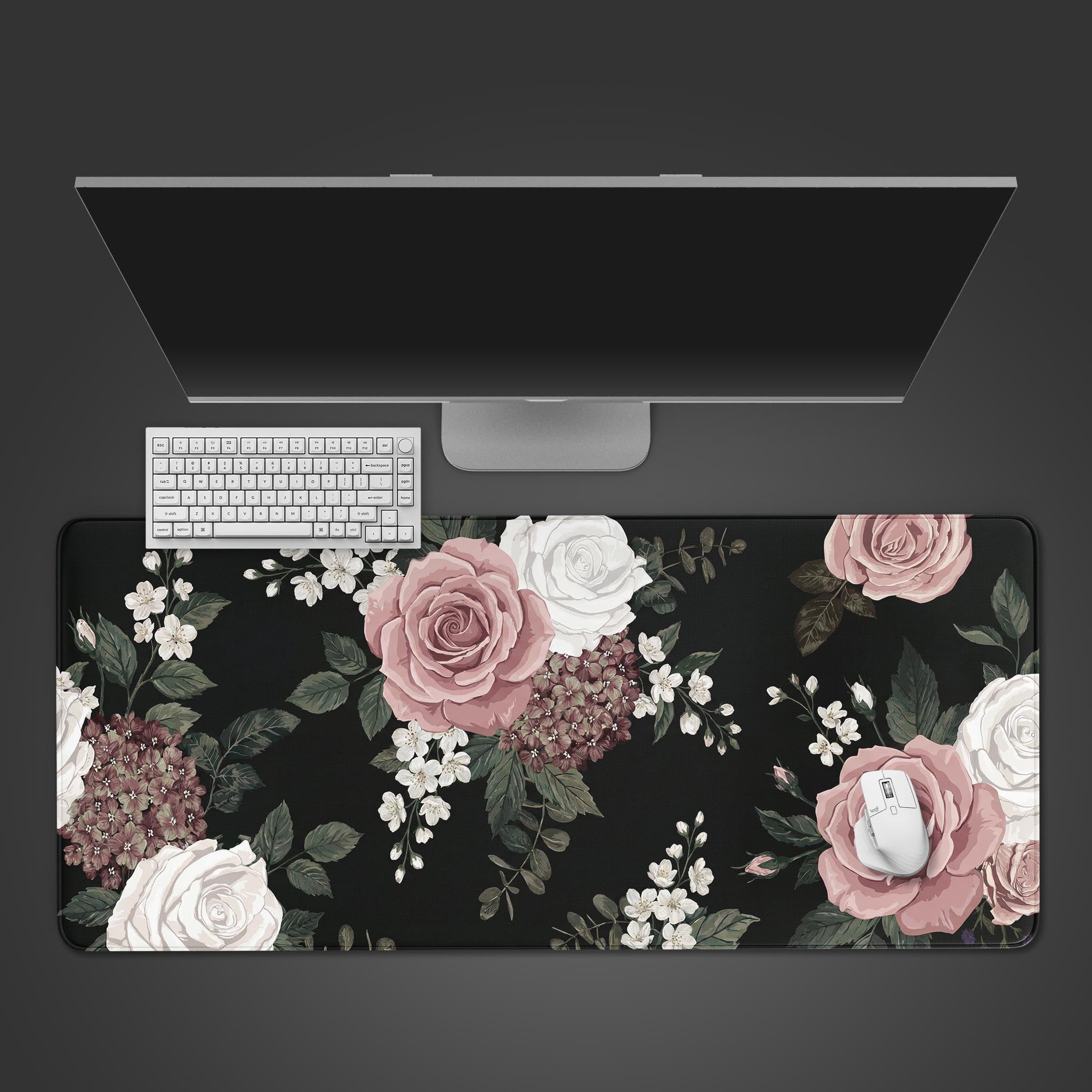 Shadowed Grace floral desk mat with vintage pink blooms on a black background, shown from a top-down view with a keyboard and mouse. - Epic Design Pads & Mousepads
