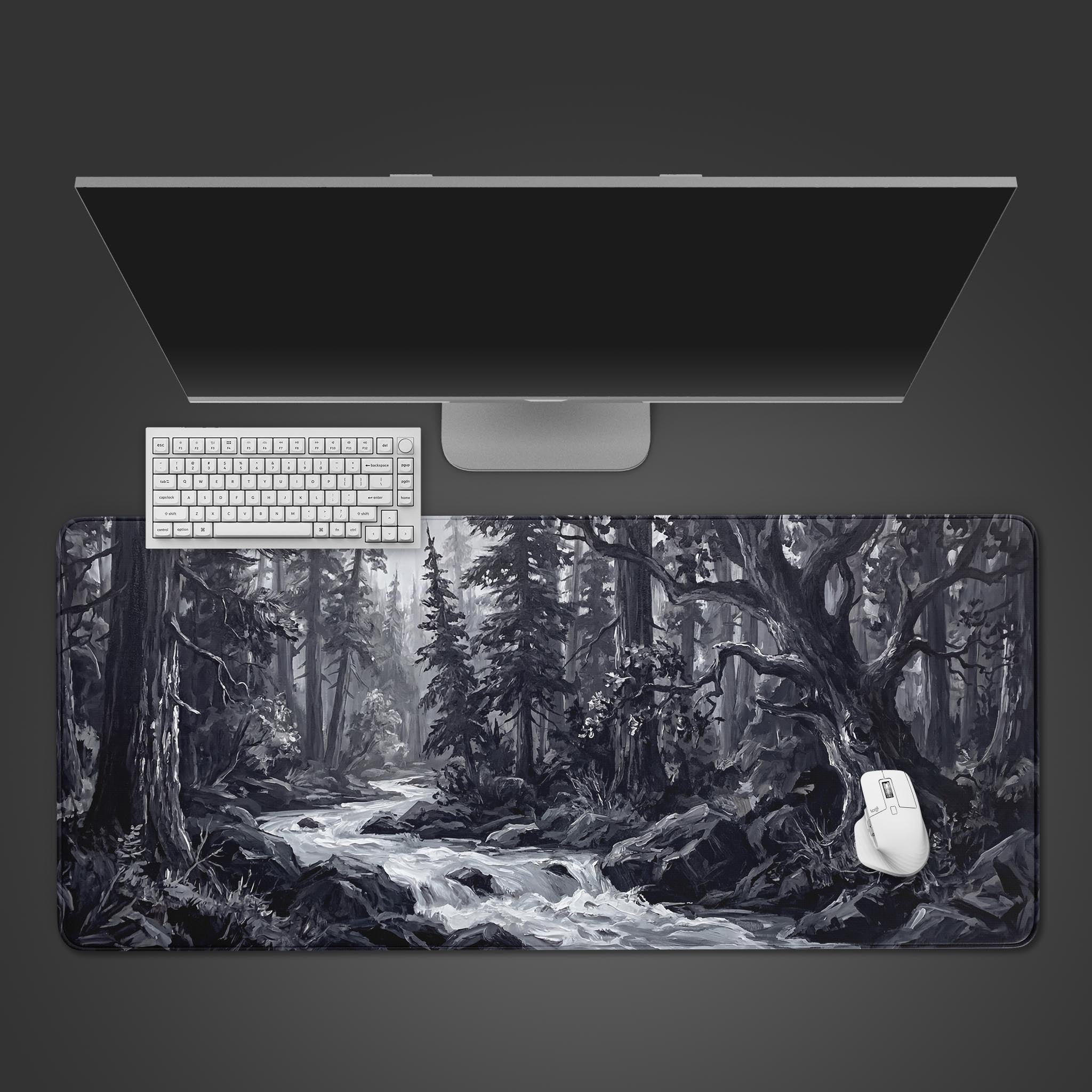 Silent Stream monochrome desk mat with a forest river design. Top-down view on a minimalist desk with a black keyboard and mouse. - Epic Design Pads & Mousepads