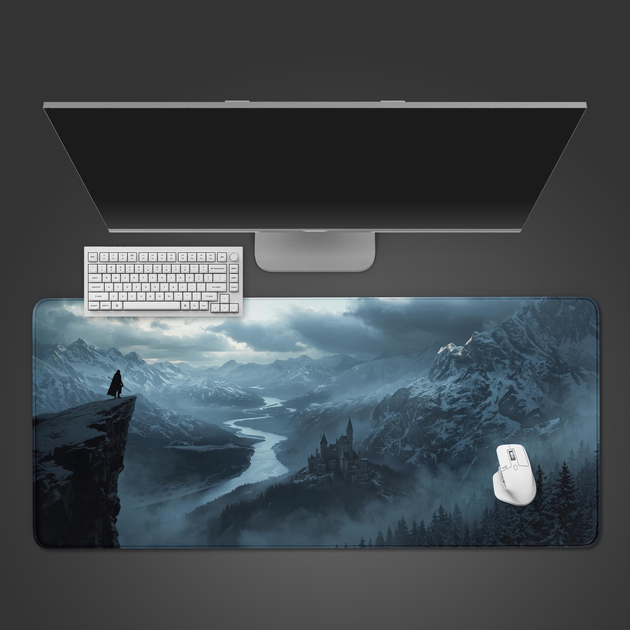 Silent Vigil fantasy desk mat with snowy mountain castle design – top-down view on a desk with keyboard and mouse. - Epic Design Pads