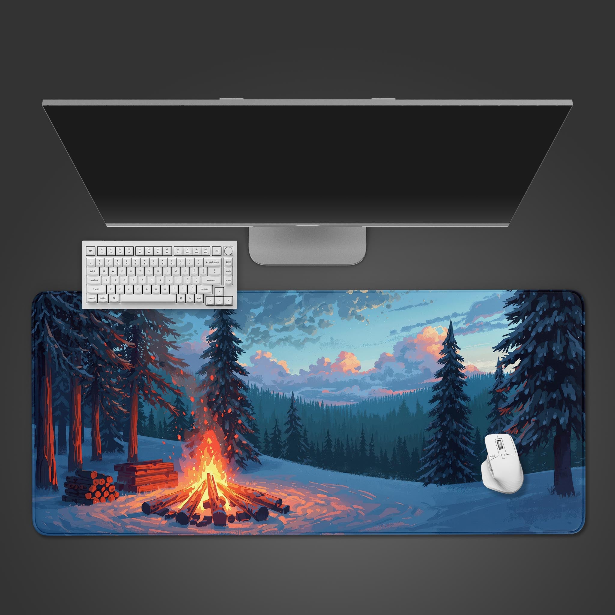 Snowy Glow desk mat with winter campfire art – top-down view on a desk with a white keyboard and mouse. - Epic Design Pads